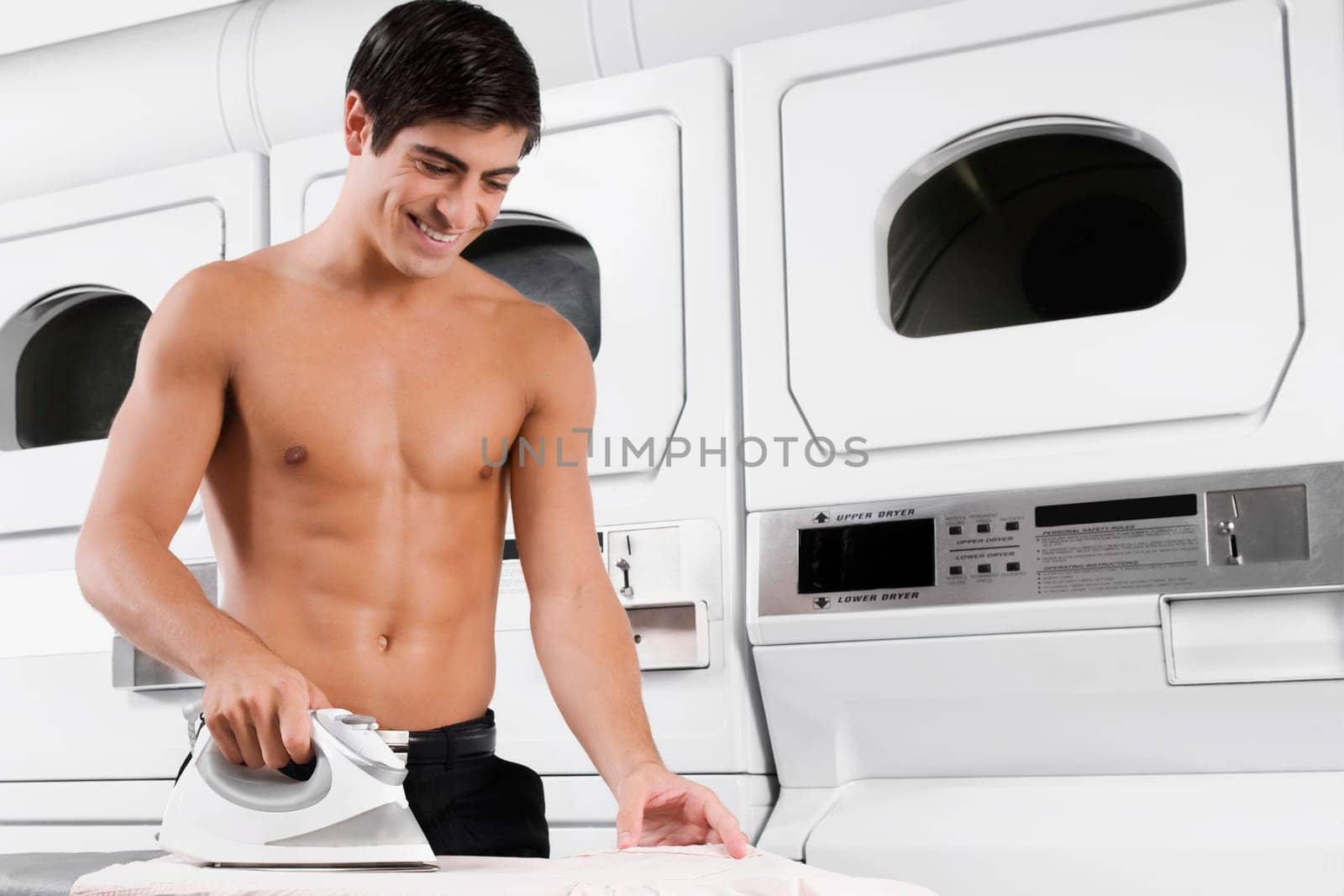 Man ironing a shirt and smiling