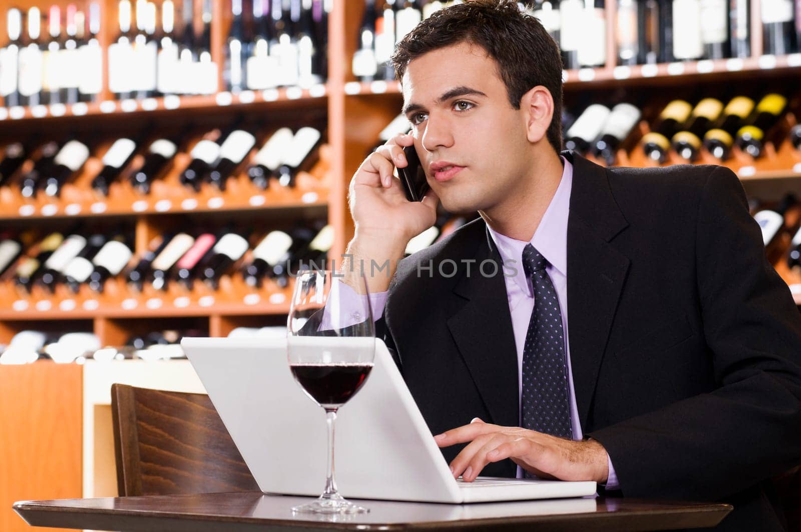 Businessman talking on a mobile phone in a bar