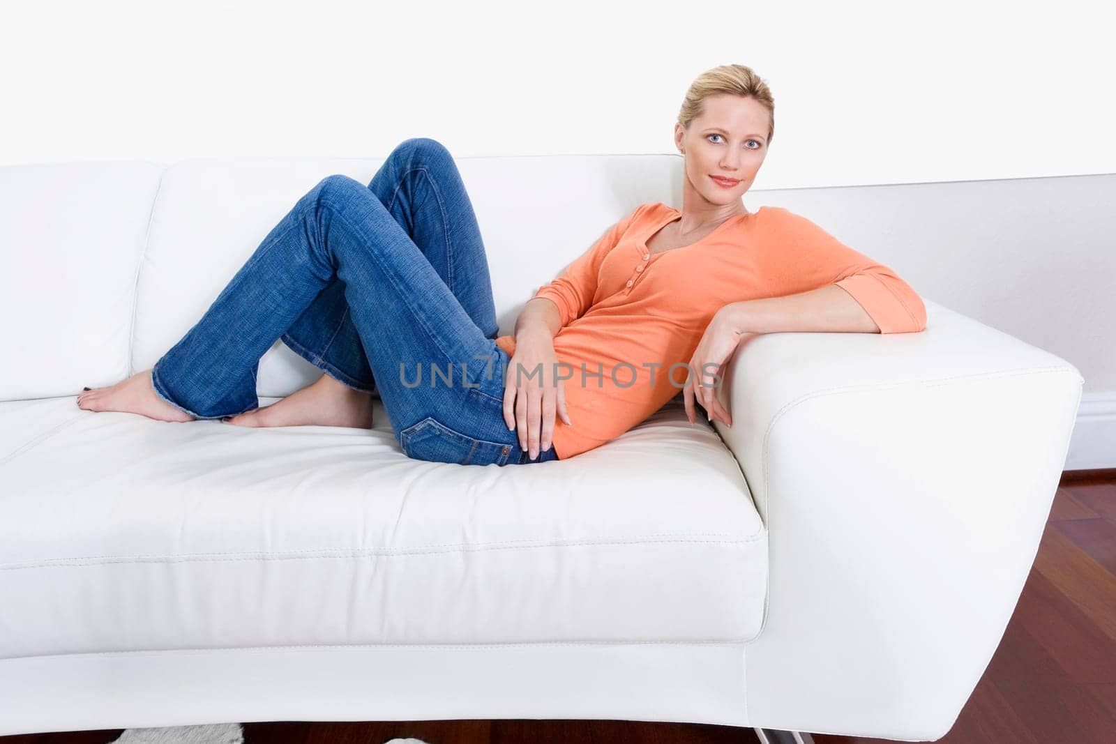 Woman reclining on a couch and smiling