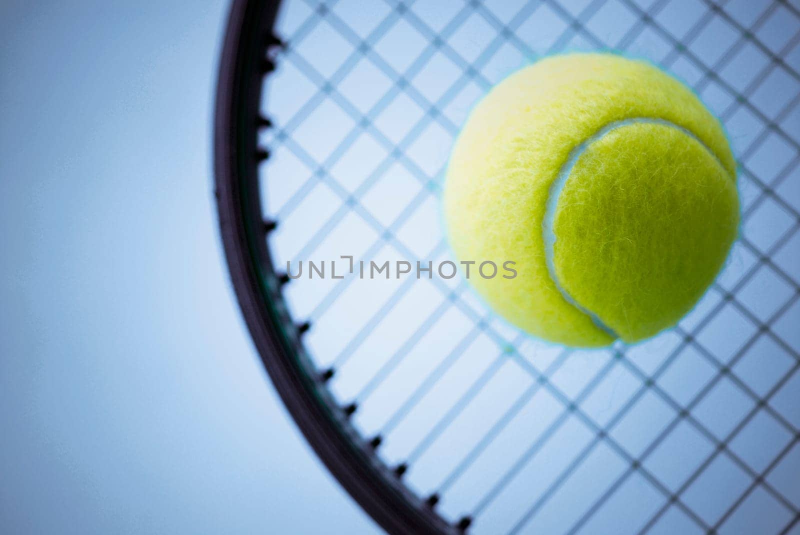 Close_up of a tennis ball and a tennis racket