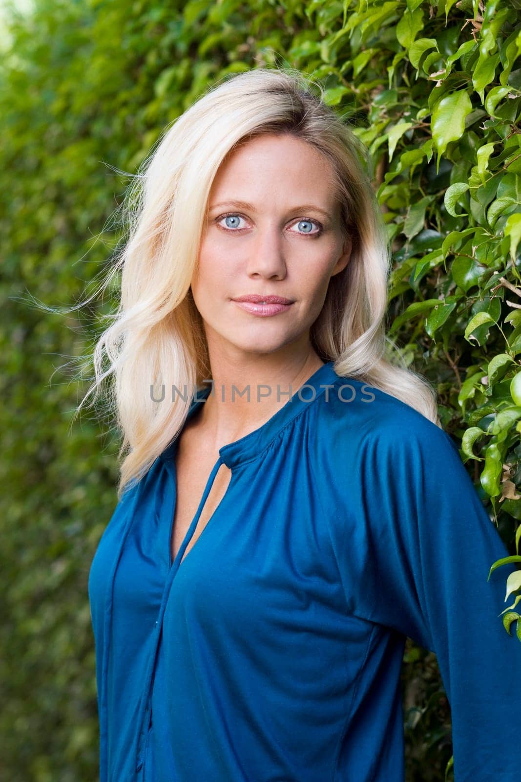 Portrait of a woman smiling in a garden