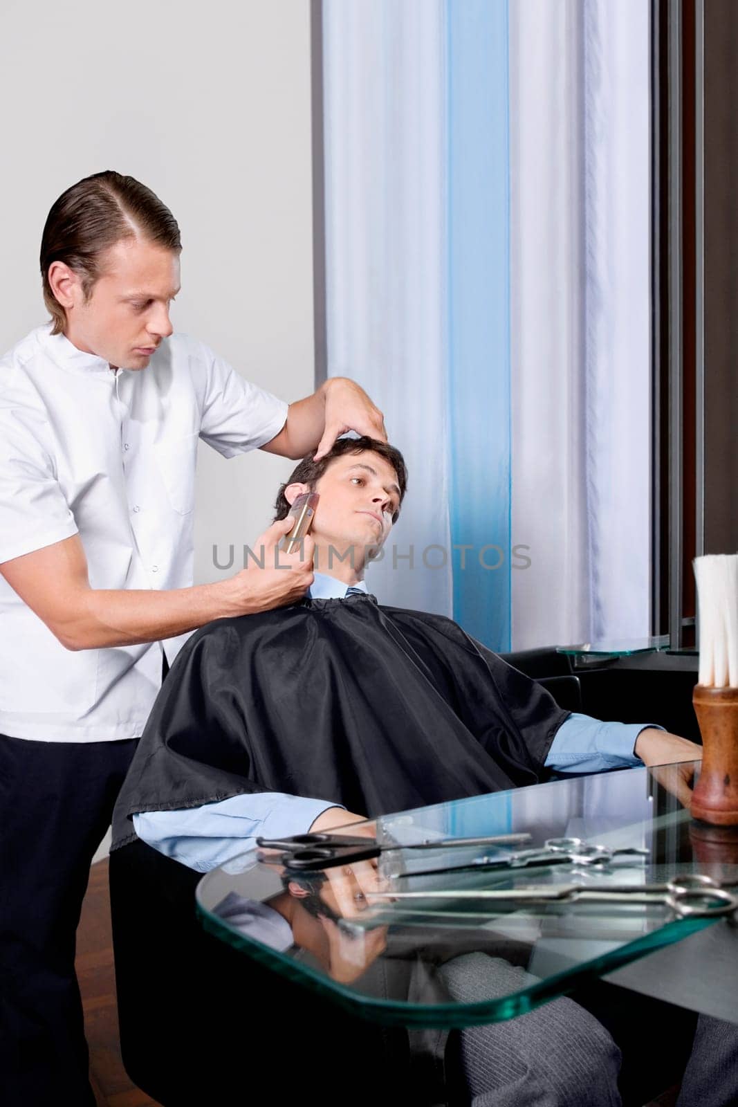 Man receiving a haircut in a salon