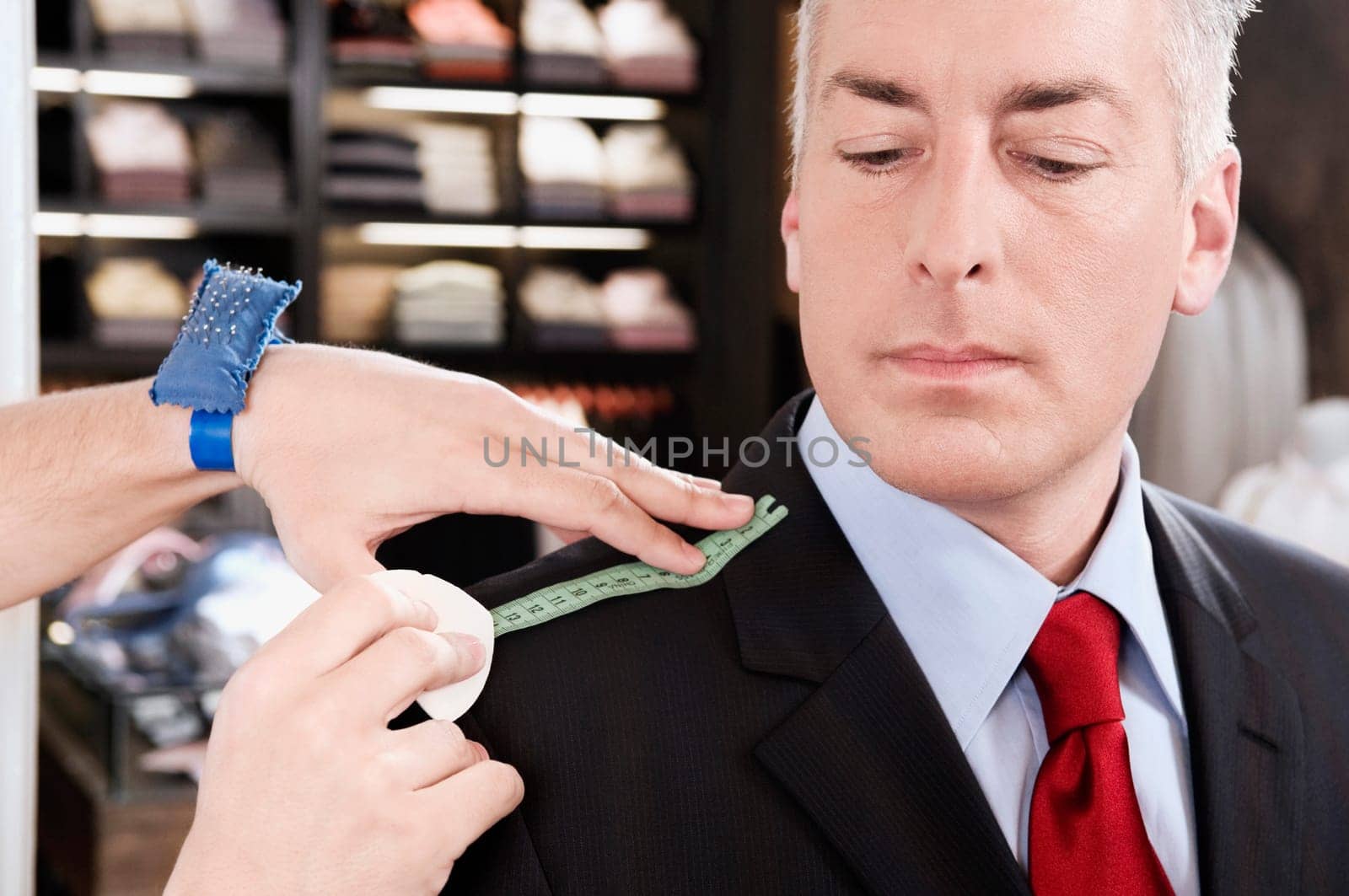 Tailor taking measurement of a businessman