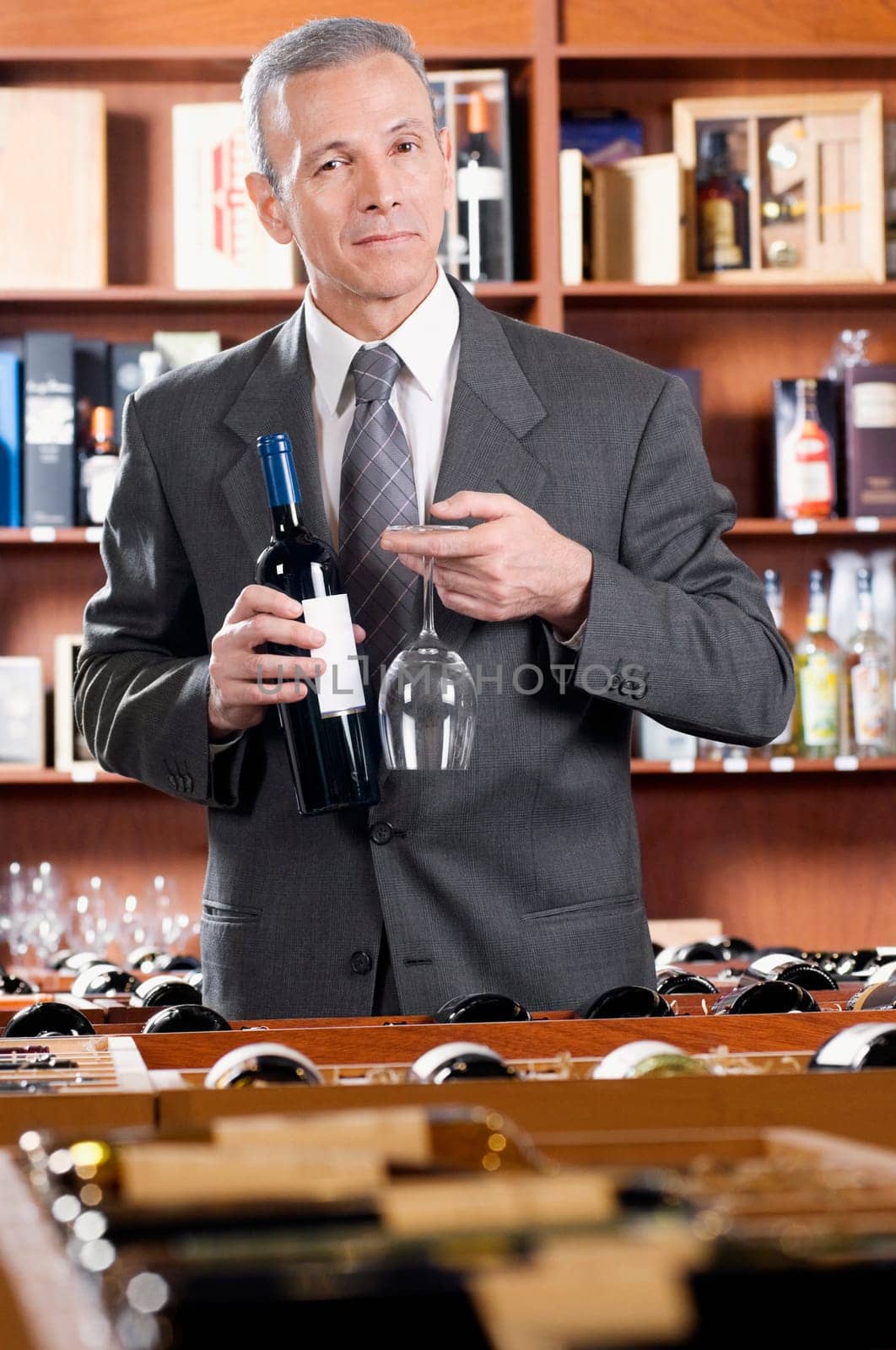 Businessman holding a wine bottle and a wine glass