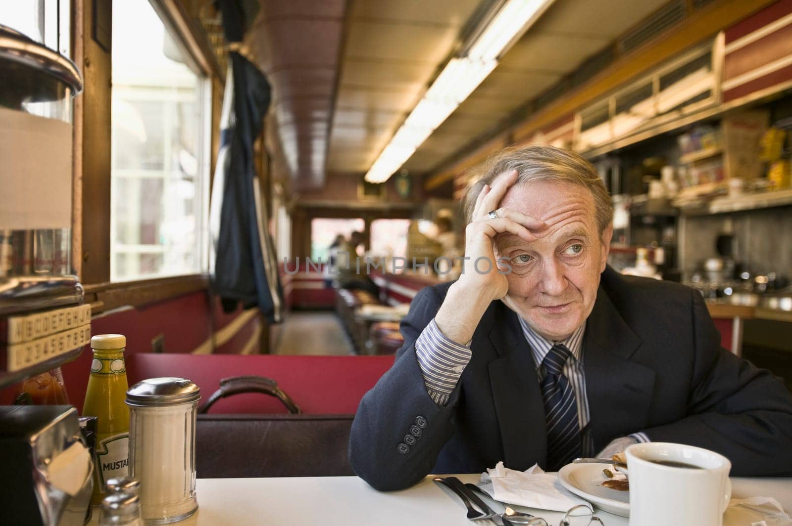 Man thinking in a restaurant