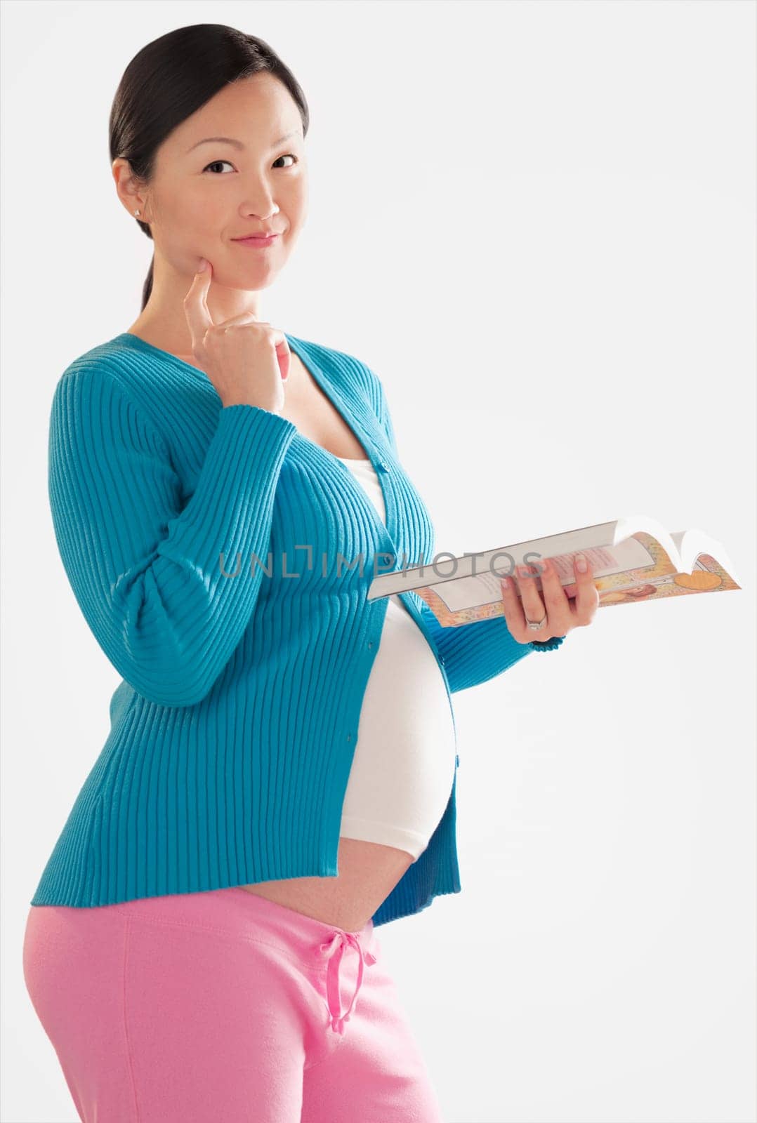Portrait of a pregnant woman holding a book