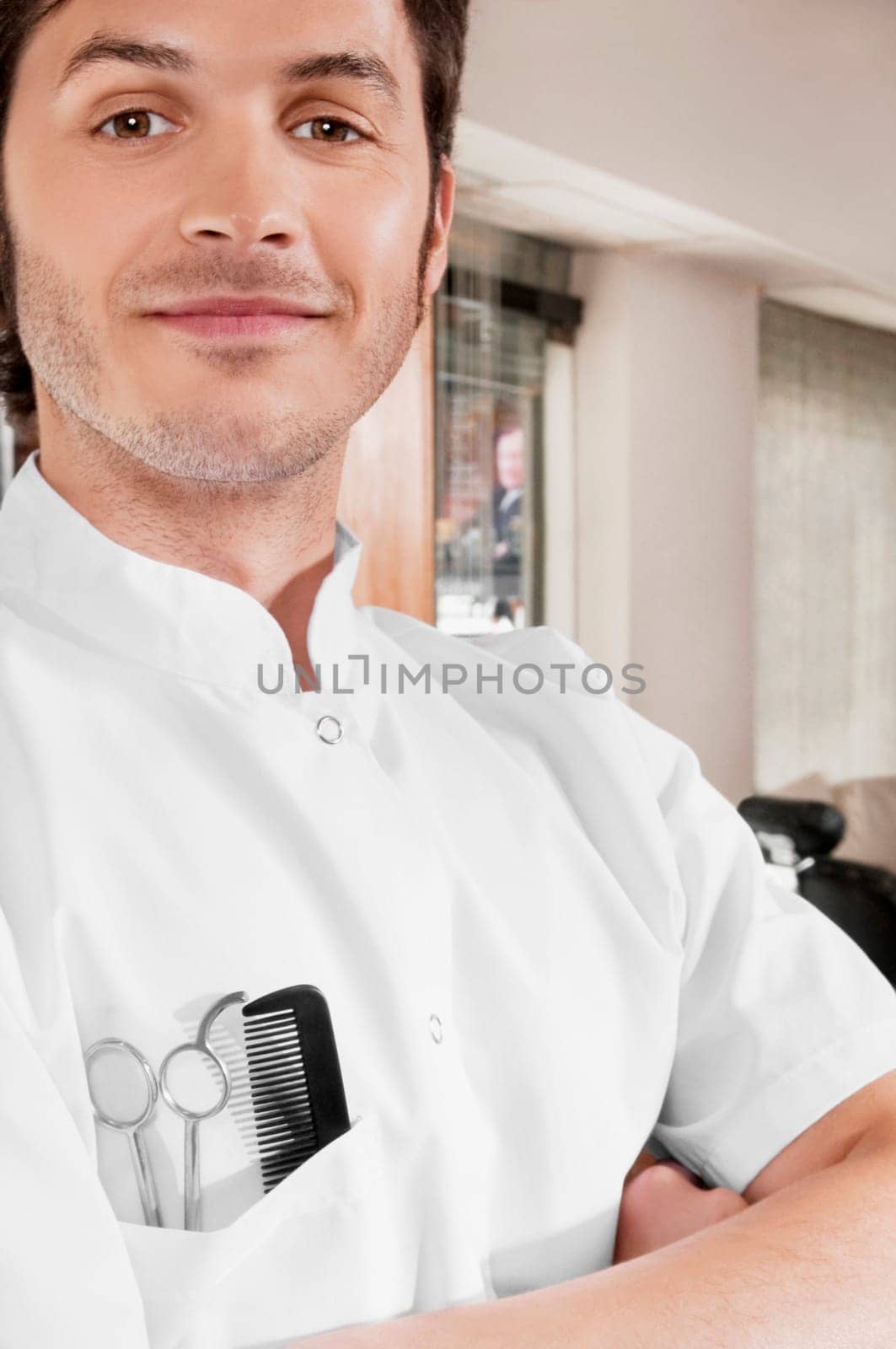 Close_up of a barber with scissors and a comb in his pocket