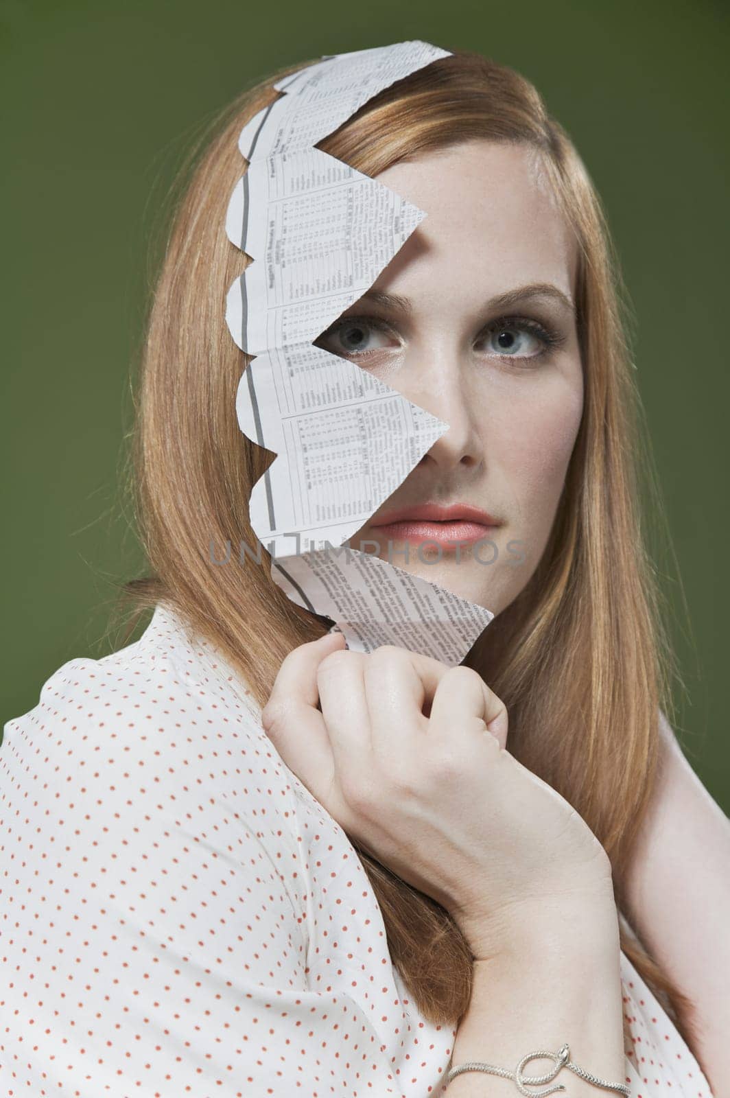 Portrait of a woman covering her face with a heart shaped paper chain