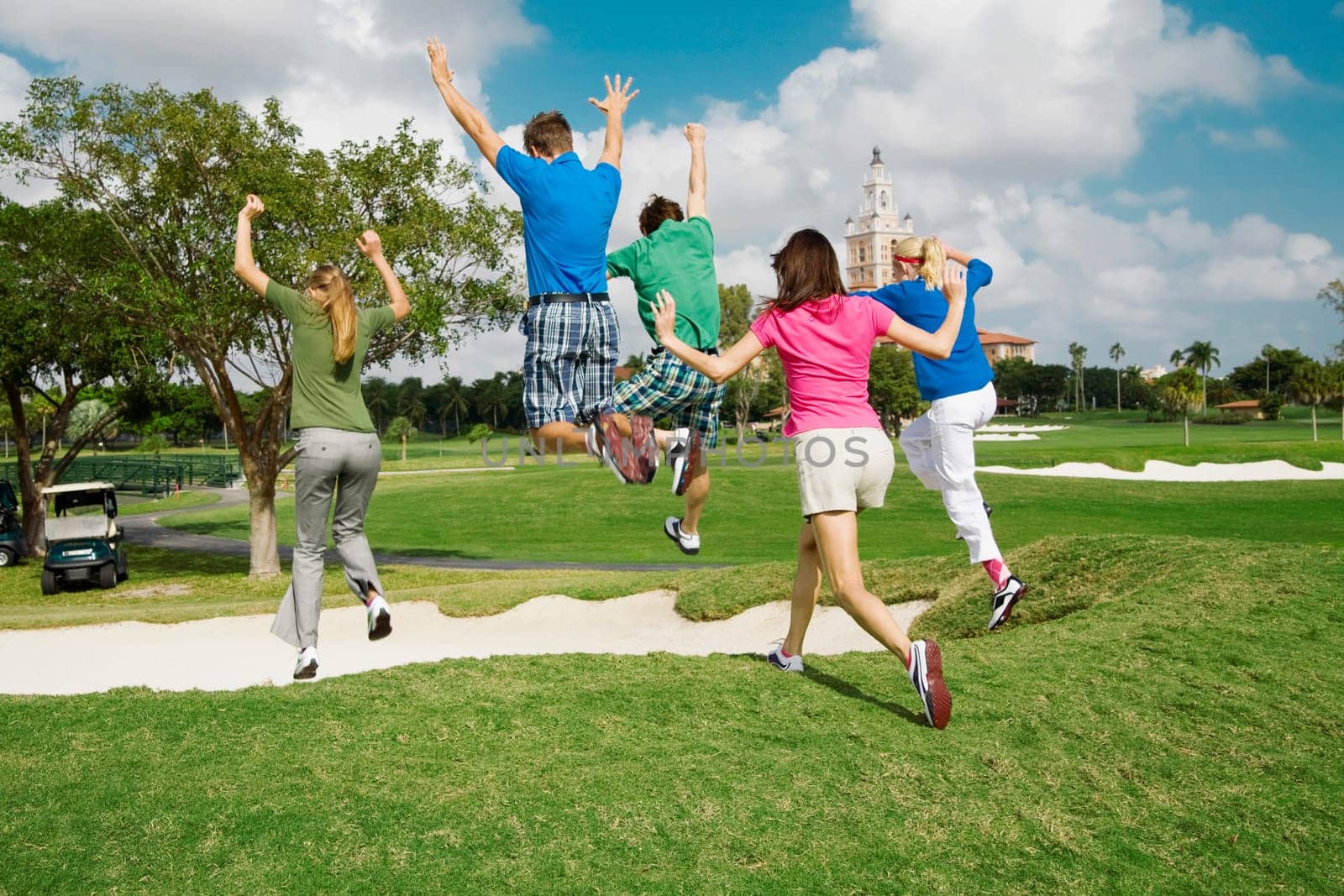 Five friends having fun in a golf course, Biltmore Golf Course, Coral Gables, Florida, USA