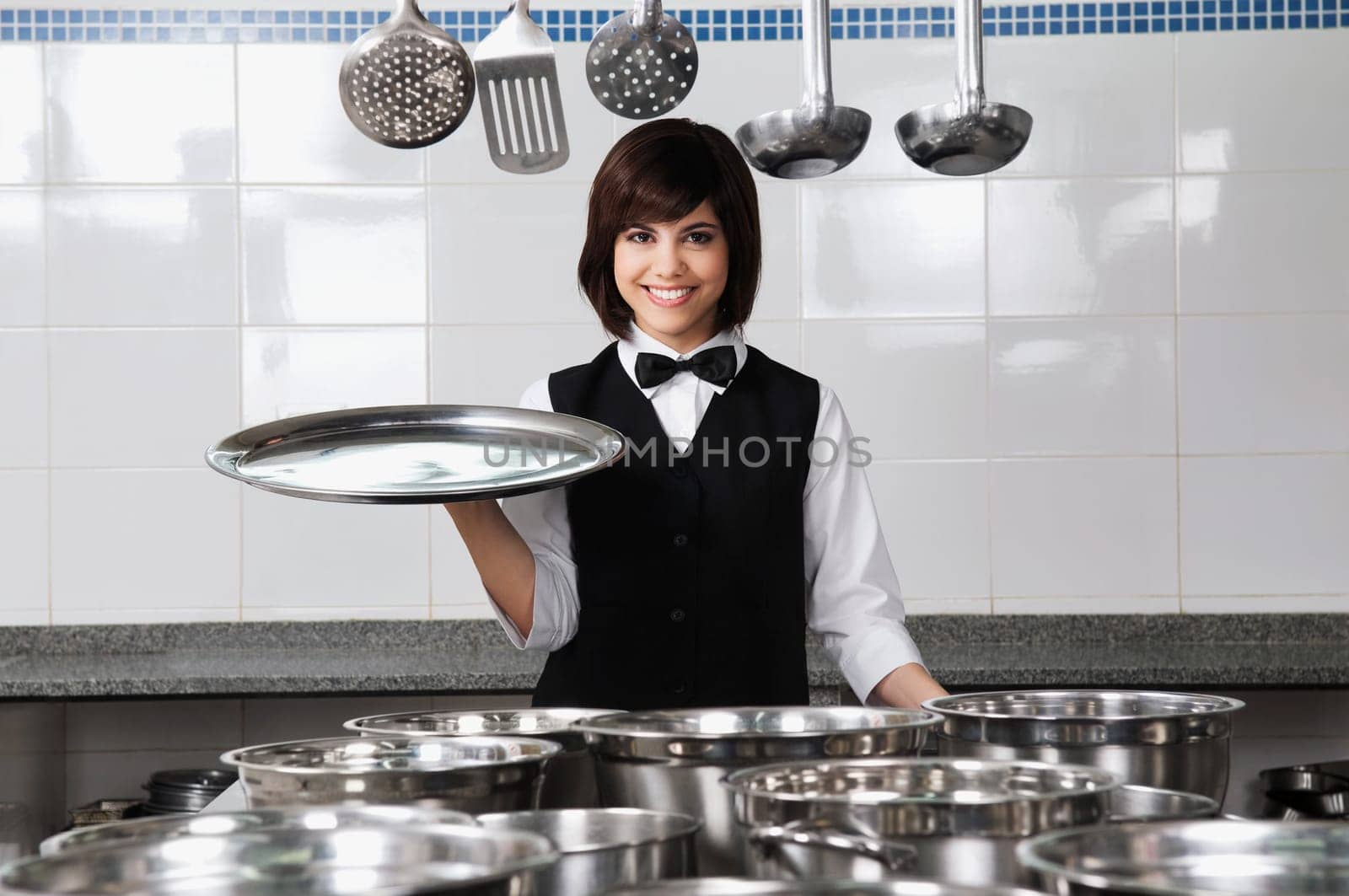 Portrait of a waitress holding a tray