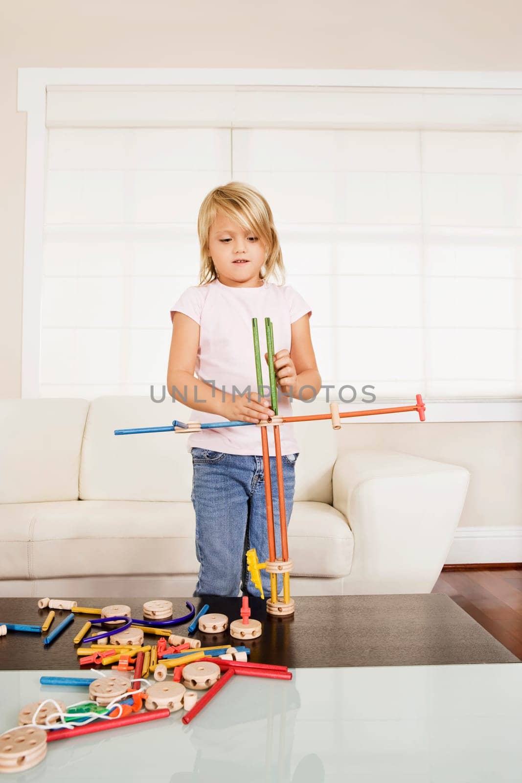 Girl assembling a toy