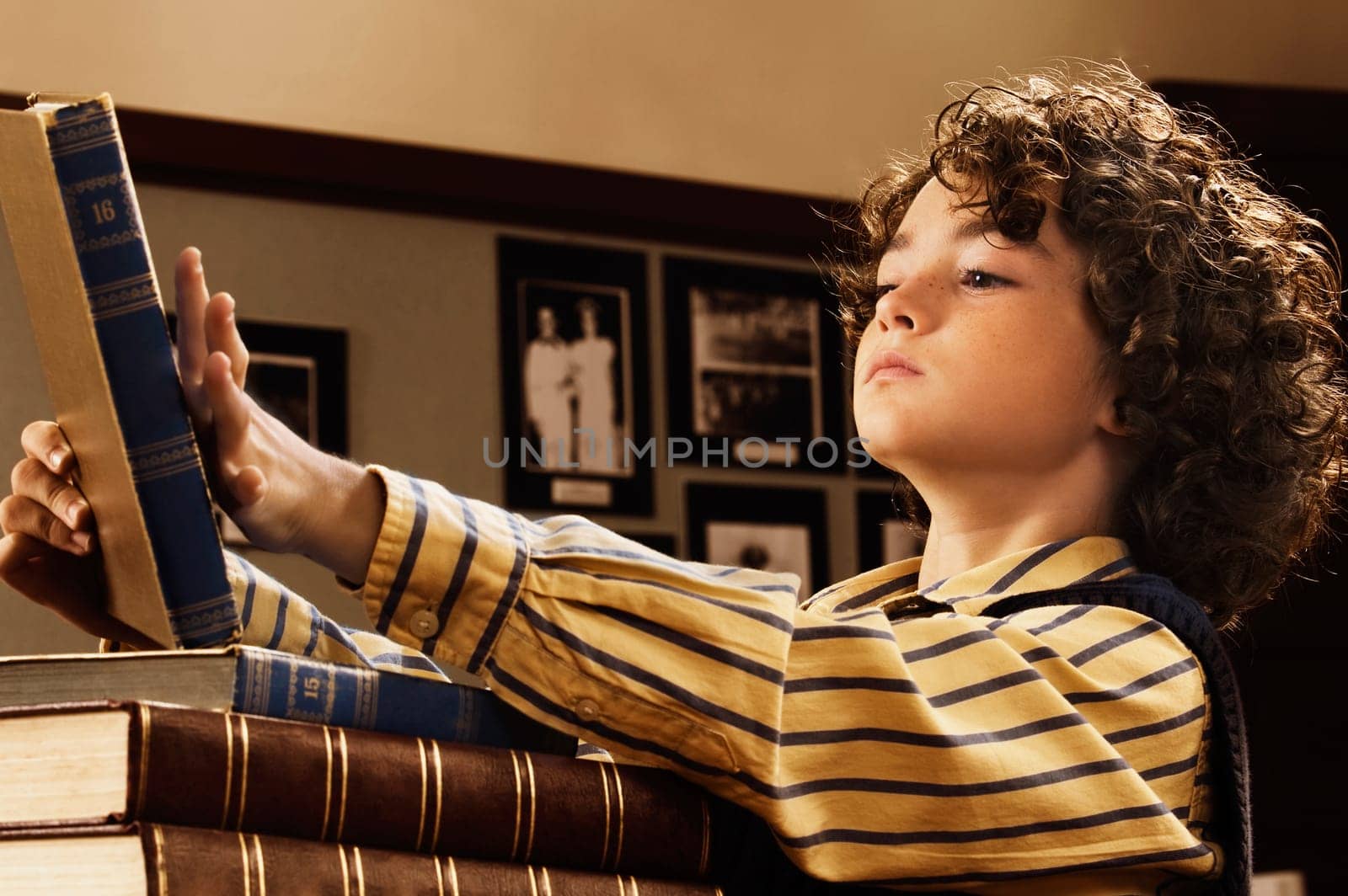 Schoolboy reading a book in a classroom