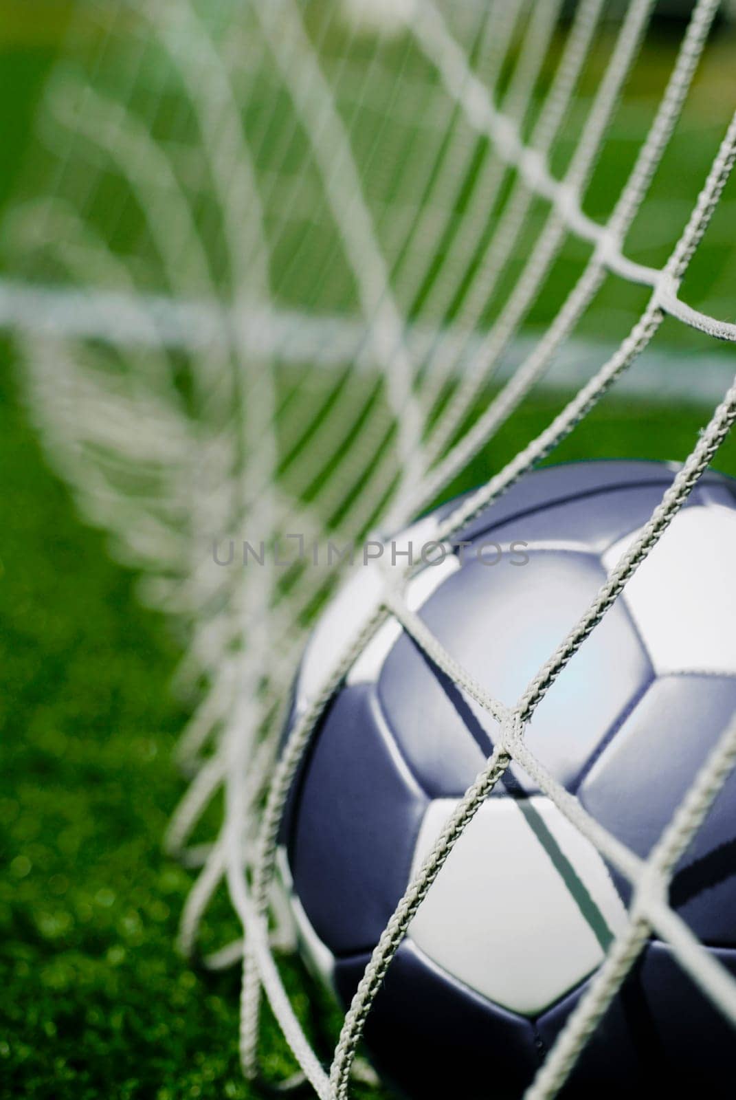 Close_up of a soccer ball in the net