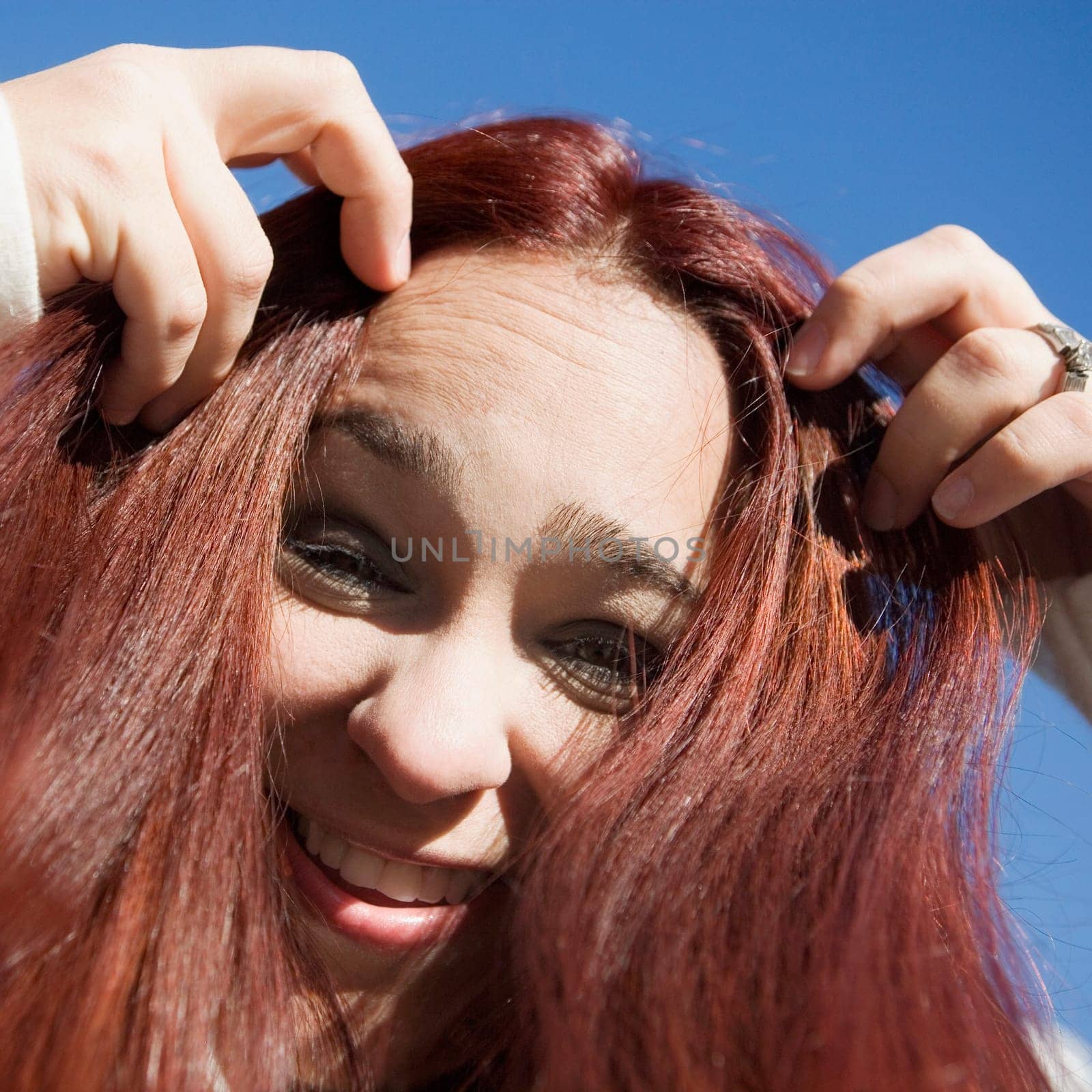 Portrait of a mid adult woman with her hands in her hair