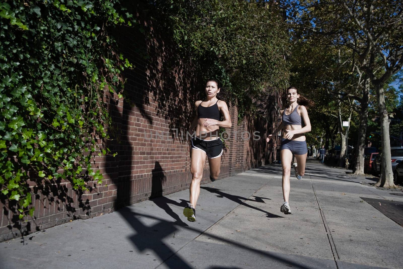 Two women jogging in the street