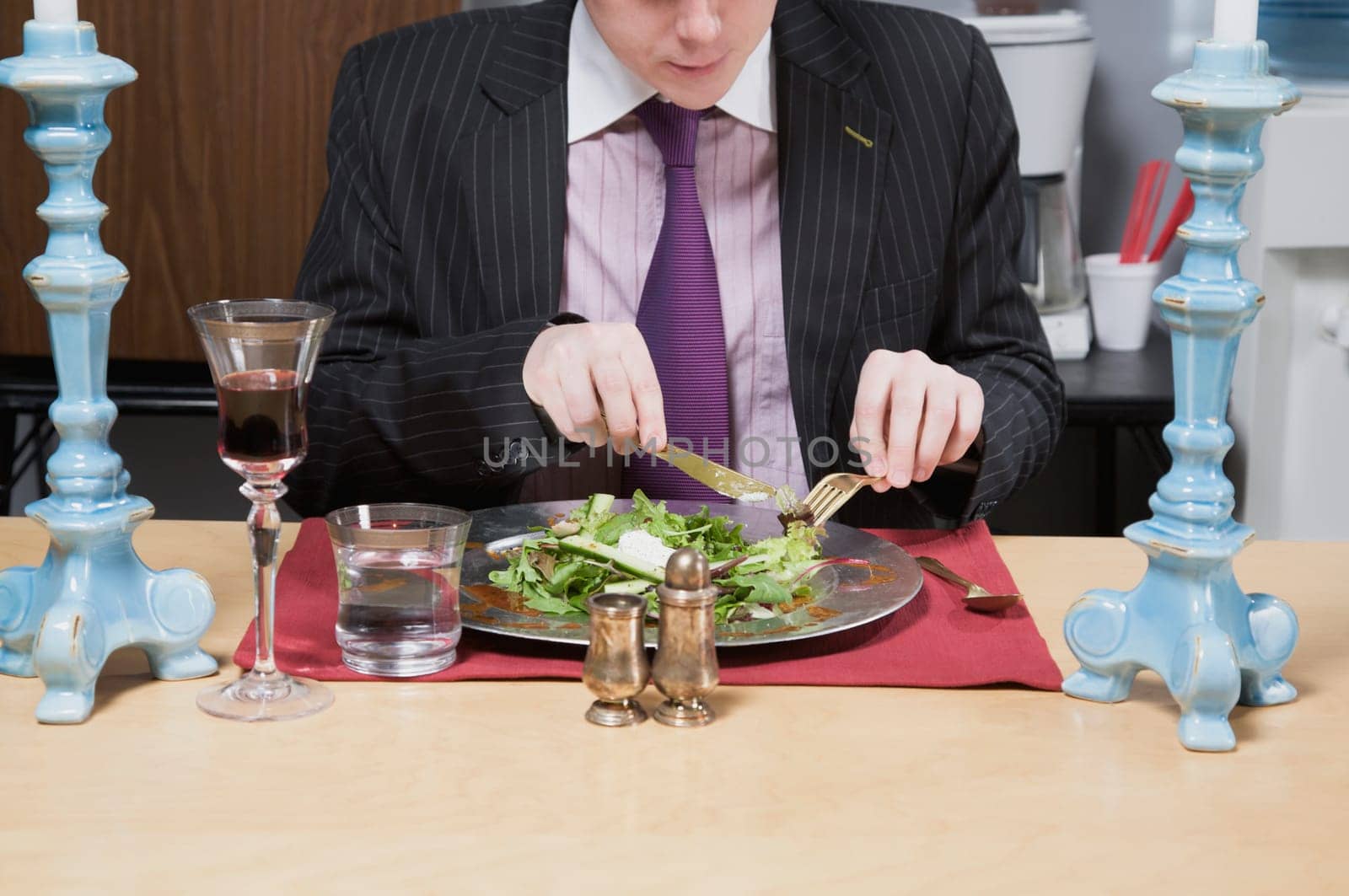 Close_up of a businessman having lunch in the office