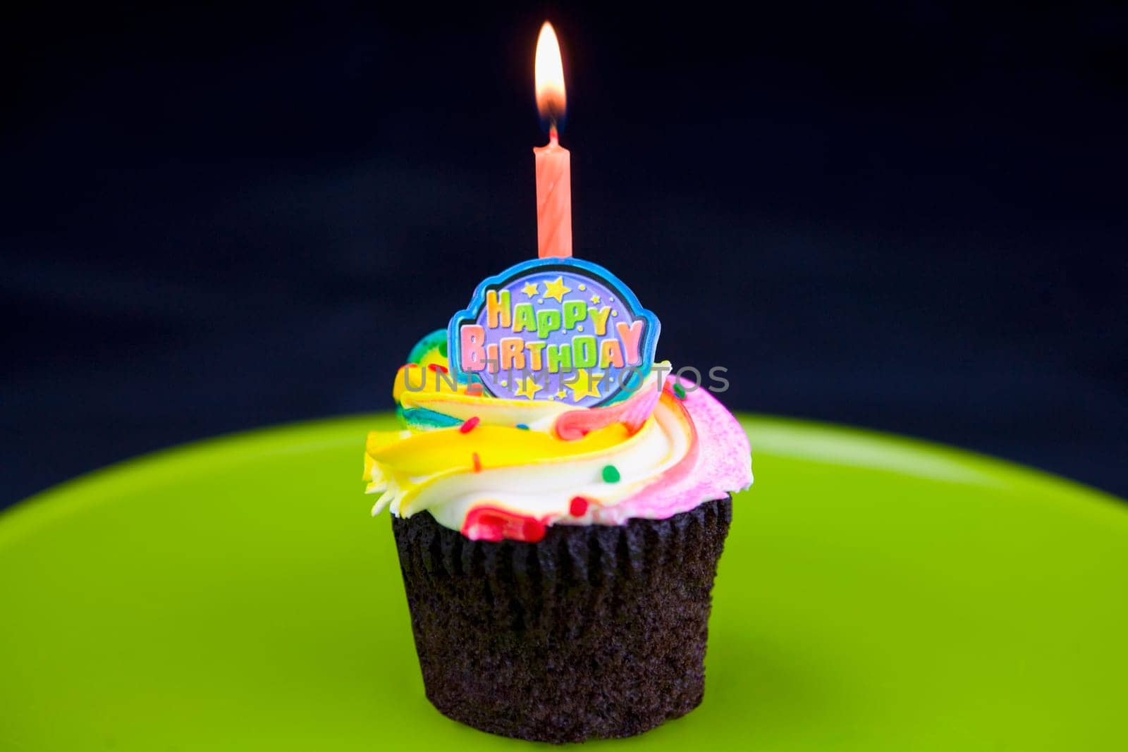 Burning candle on a birthday cake
