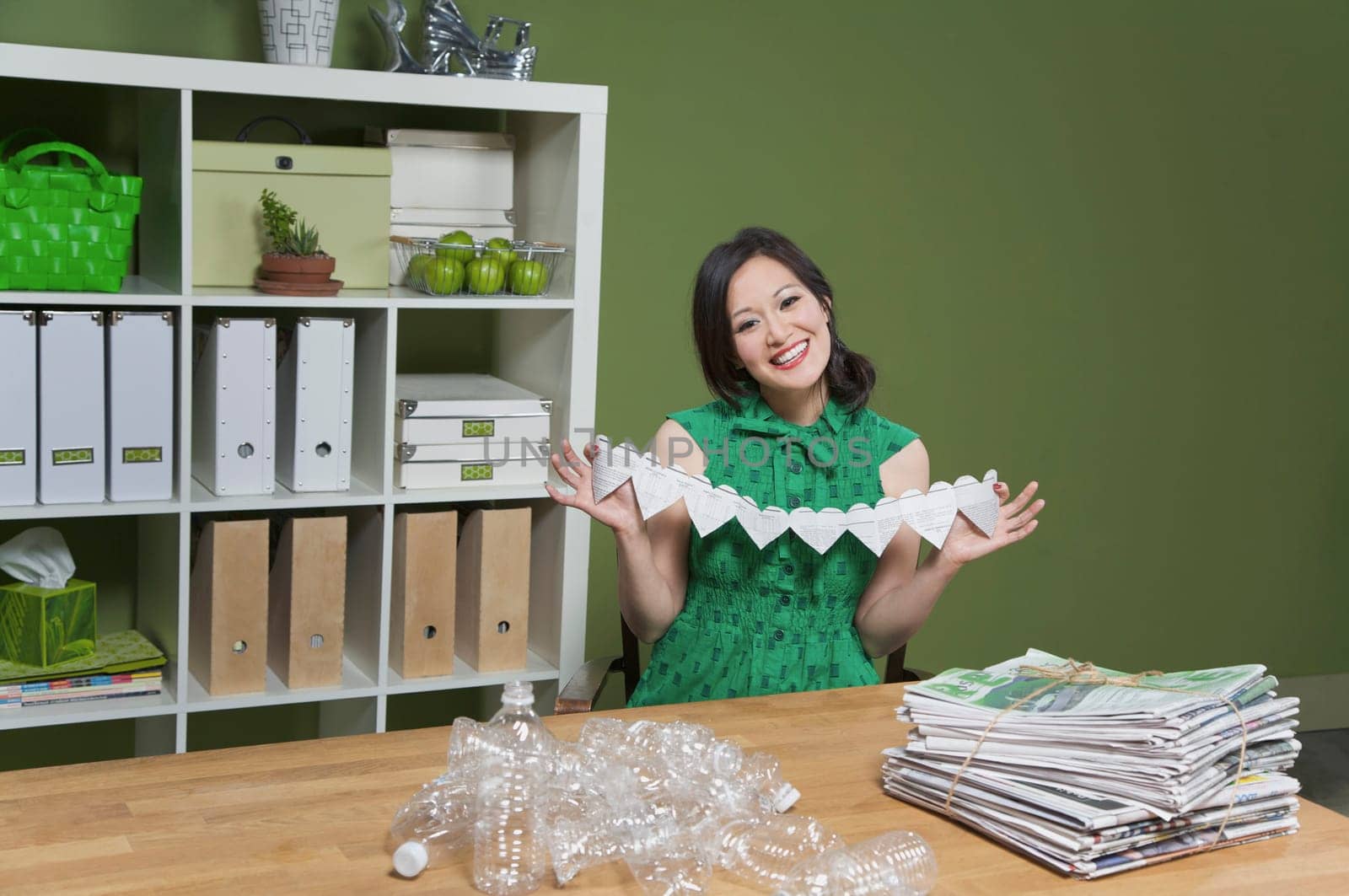 Portrait of a woman showing a paper chain
