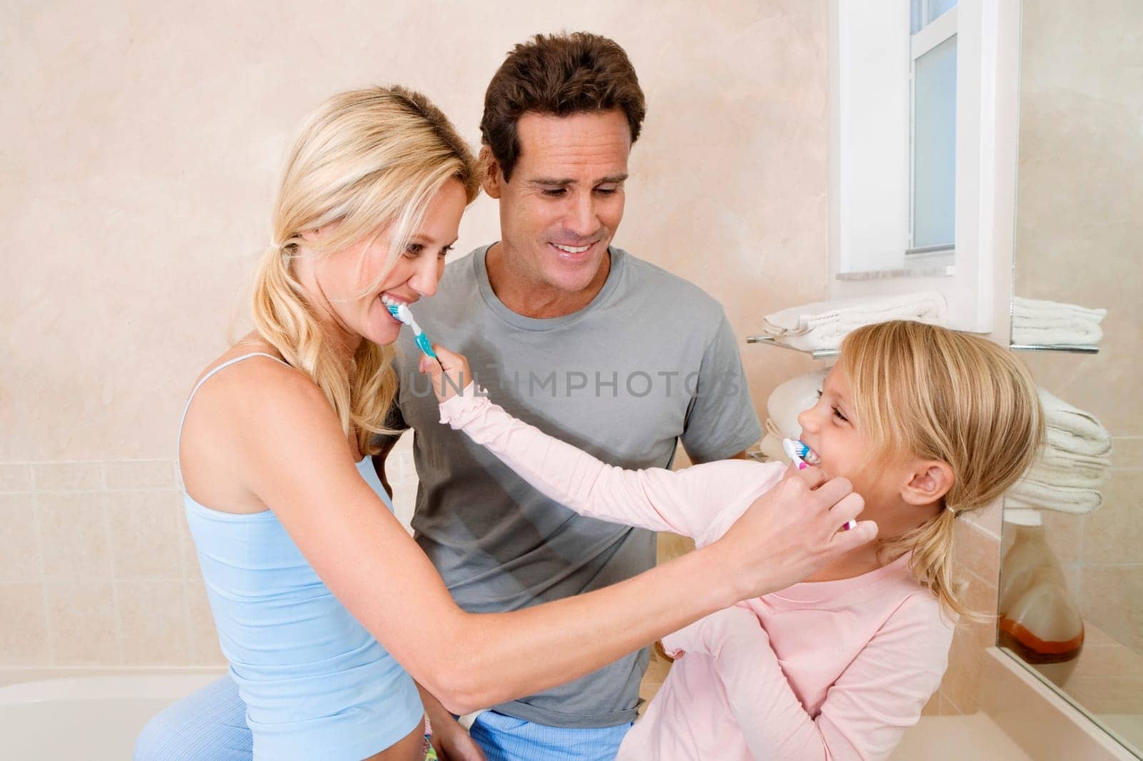 Family brushing teeth in the bathroom