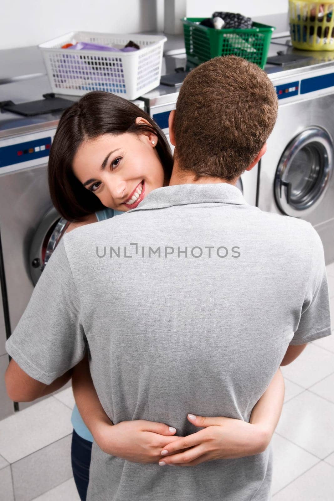 Couple hugging in a laundromat
