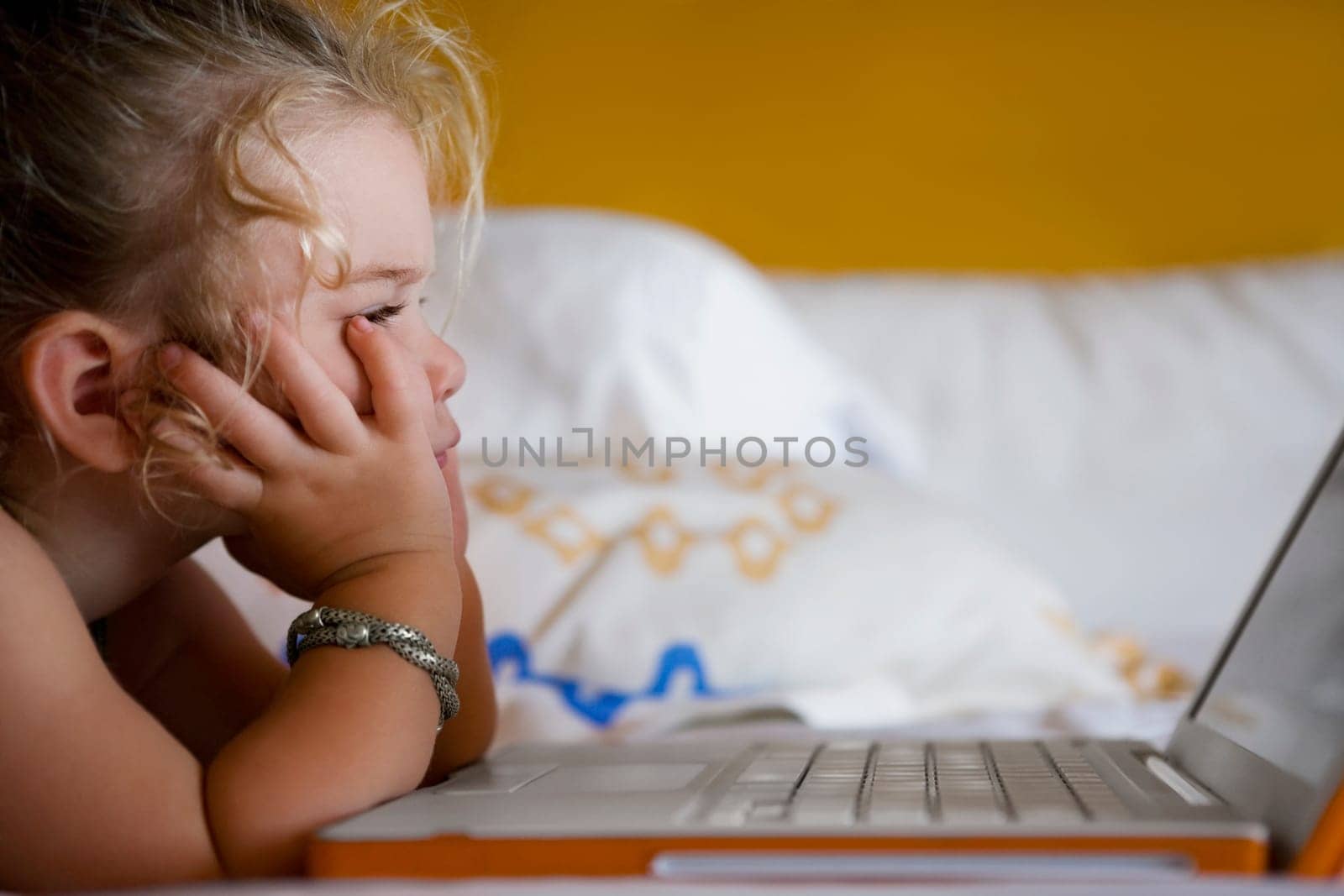 Baby girl looking at a laptop