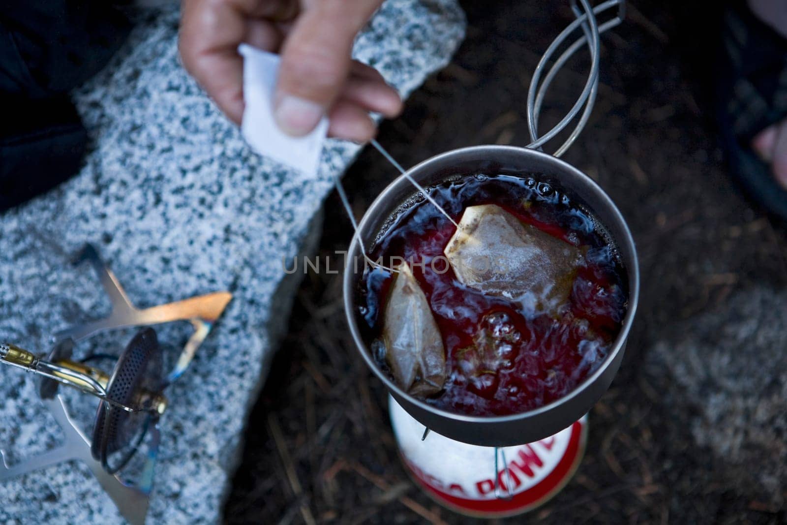 Close_up of a personŽs hand making tea