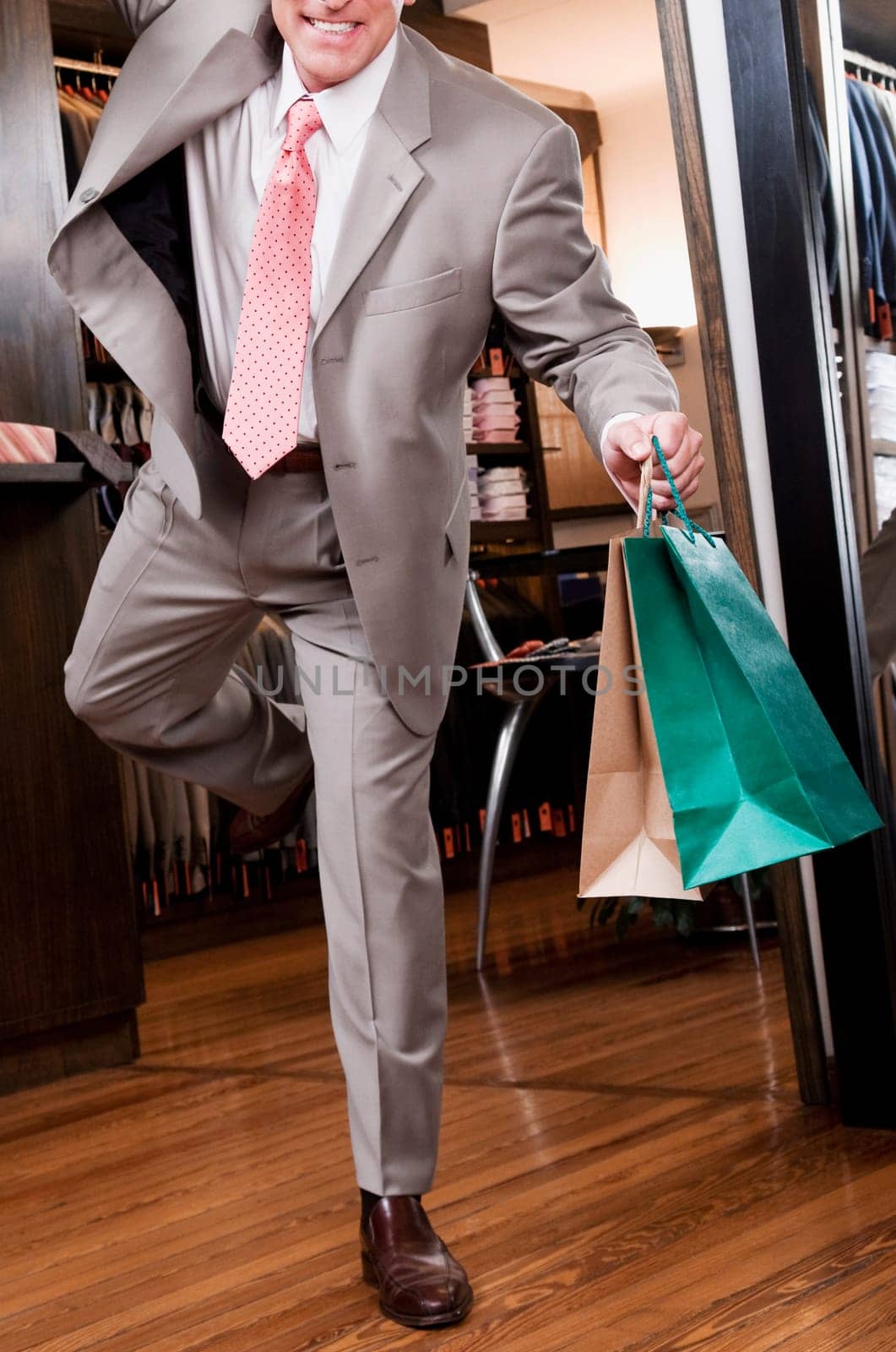 Businessman holding shopping bags in a clothing store