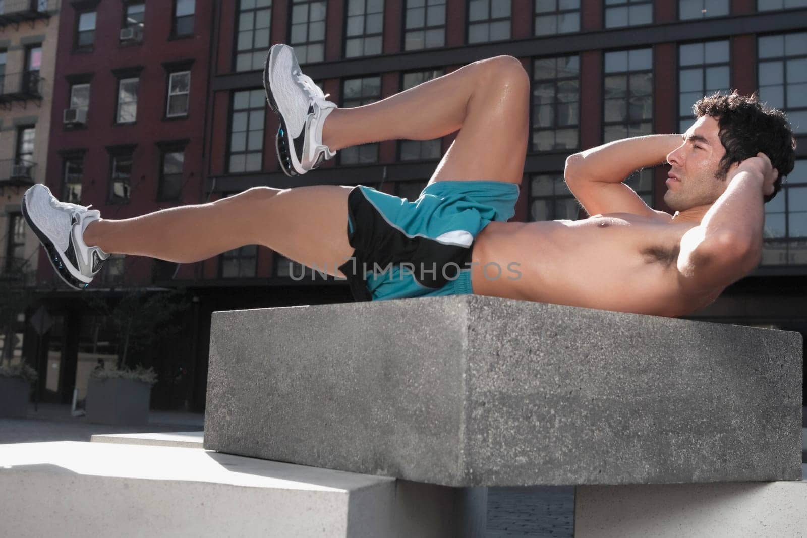 Man exercising on a stone