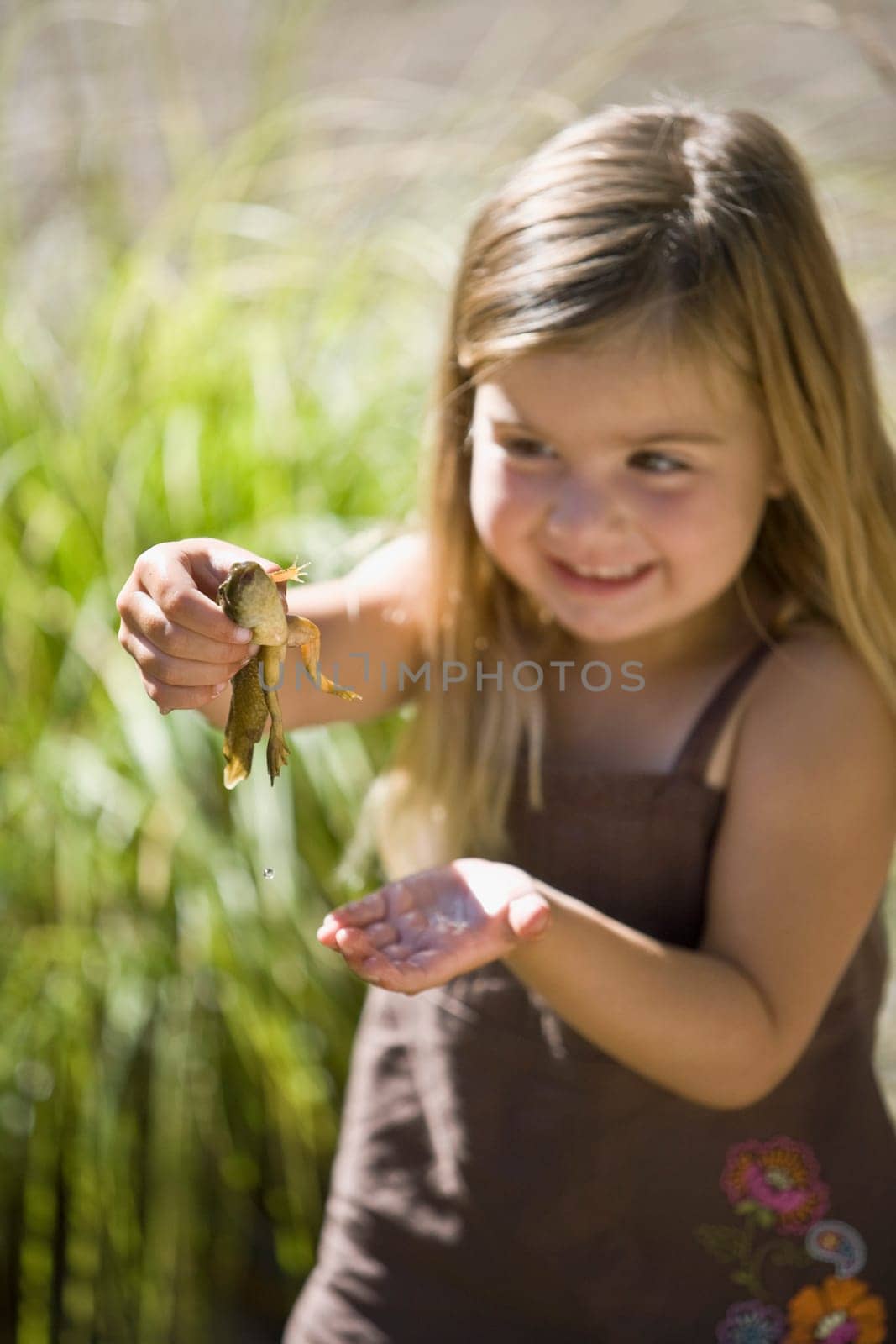 Close_up of a girl holding a frog