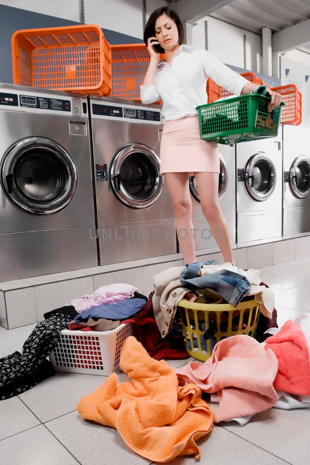 Woman talking on a mobile phone in a laundromat