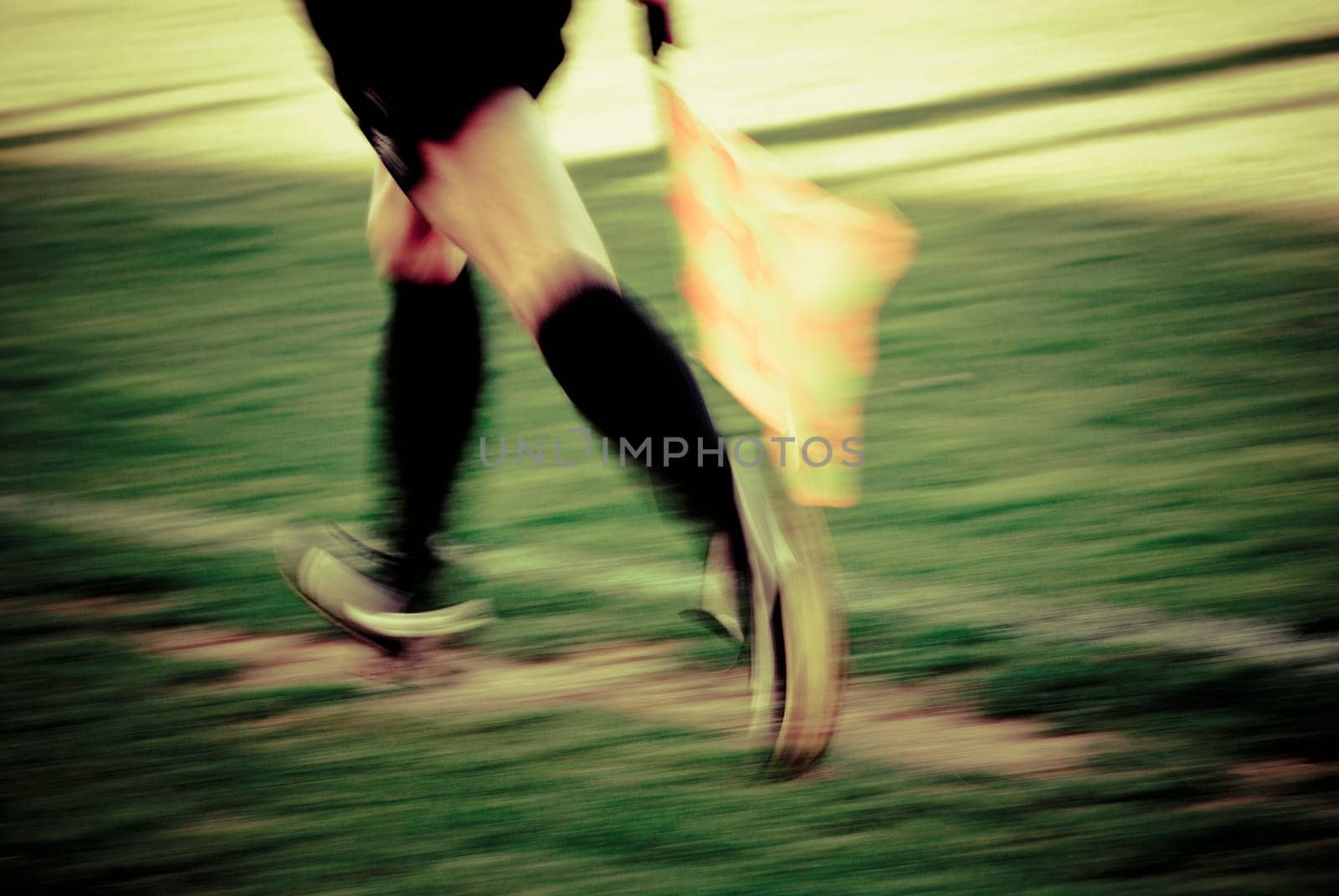Low section view of a lineman running with a flag