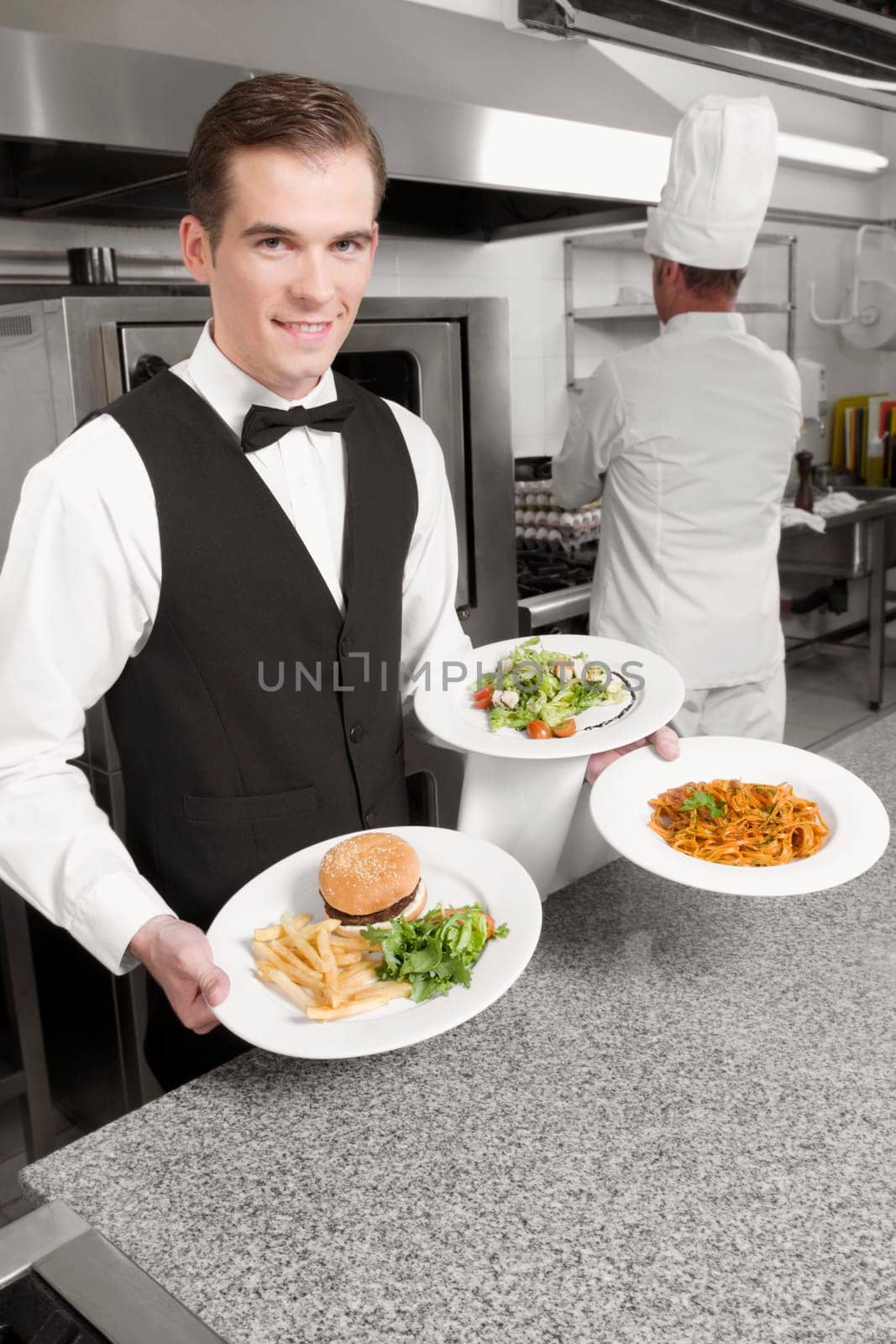 Waiter holding plates of foods