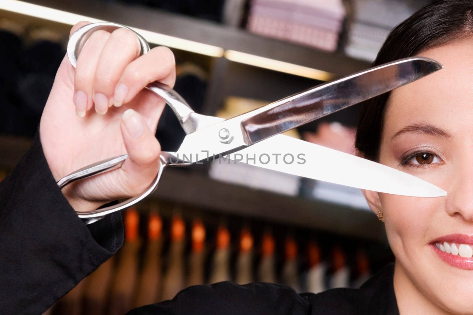 Portrait of a female tailor holding scissors