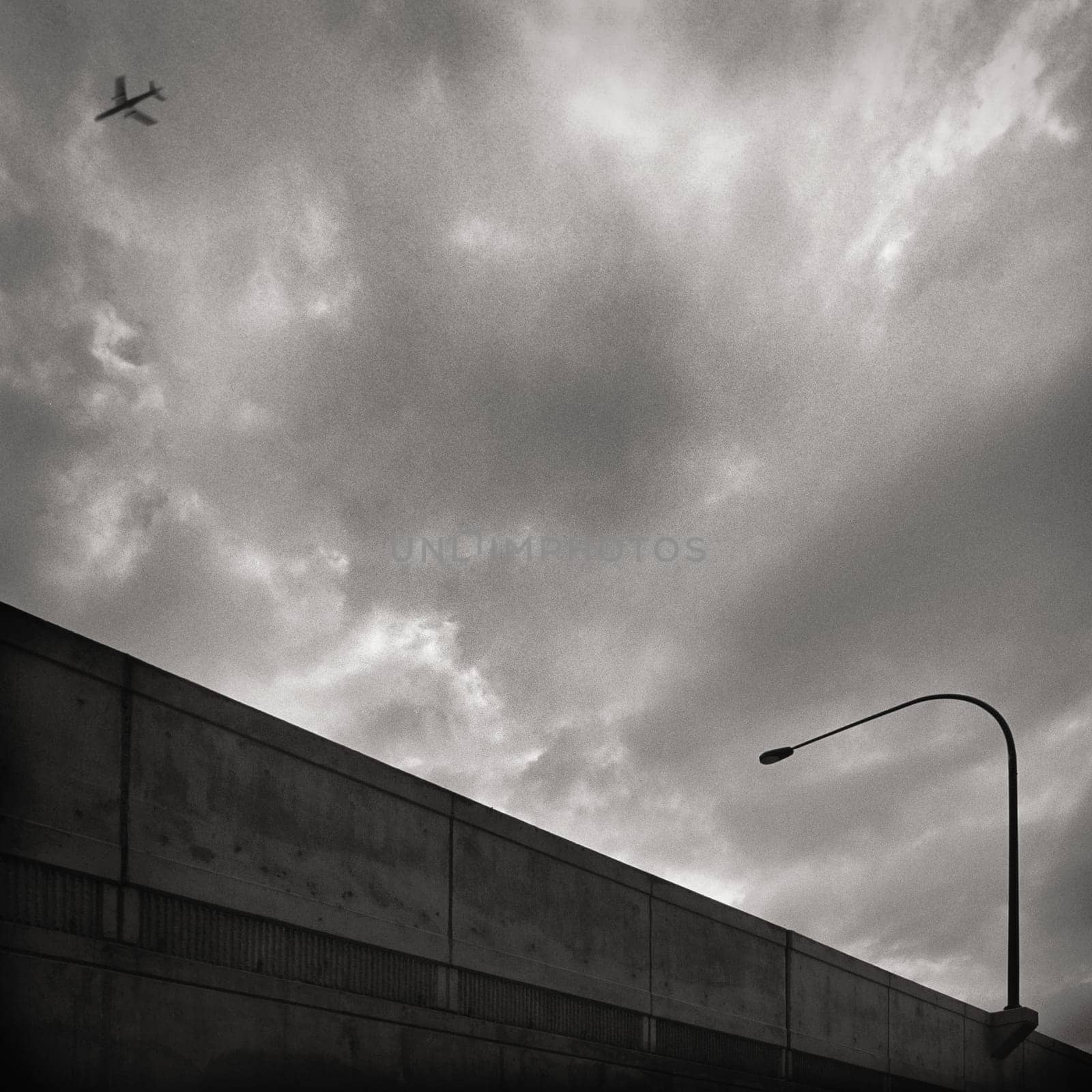 Low angle view of an airplane flying in the cloudy sky