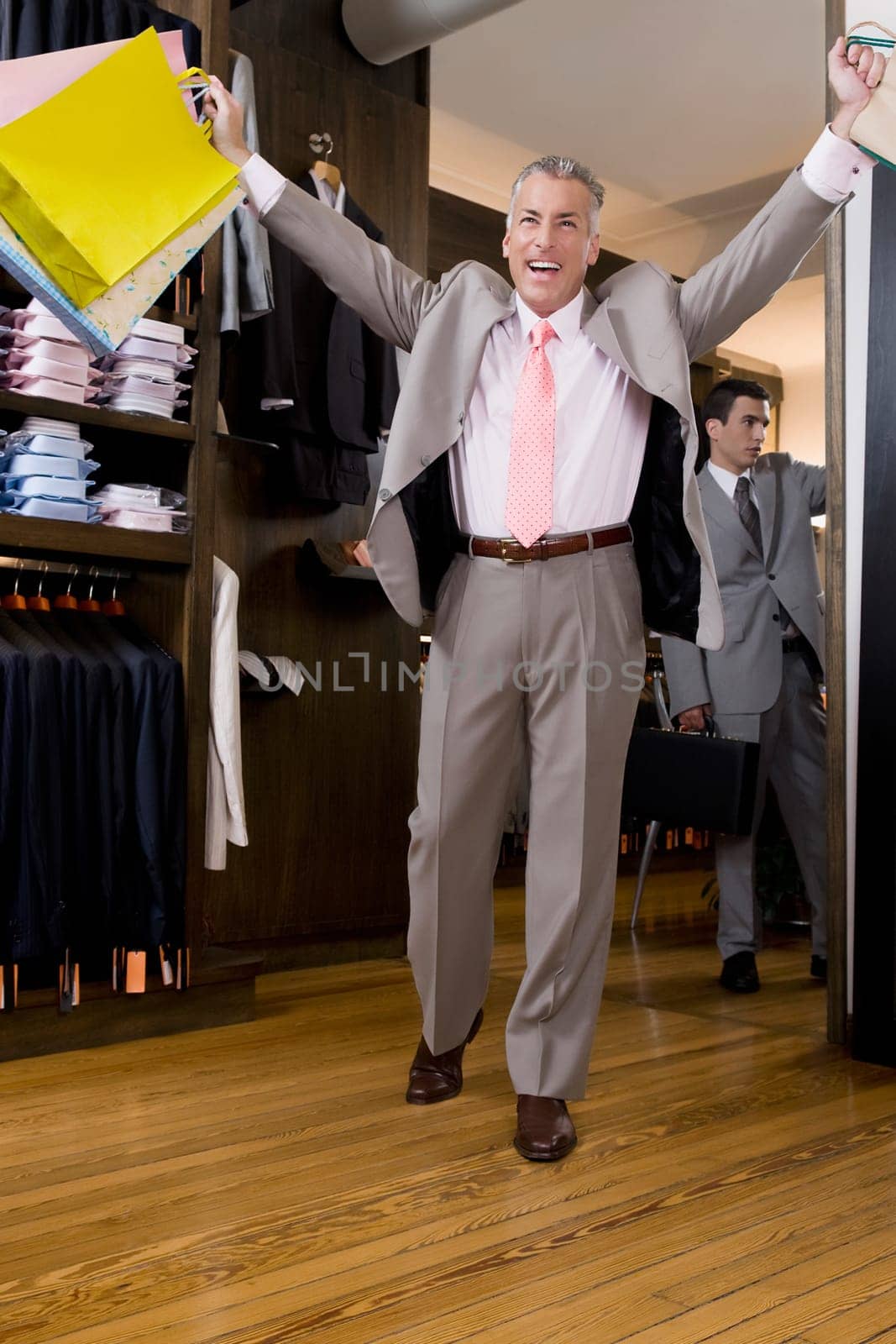 Businessman holding shopping bags in a clothing store