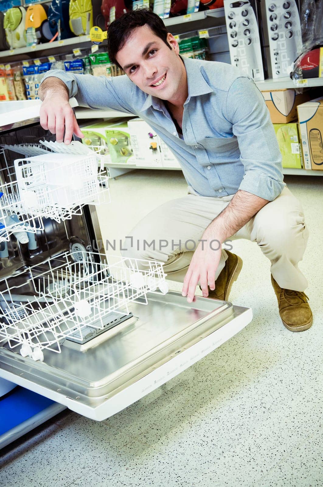 Man buying a dishwasher in a supermarket