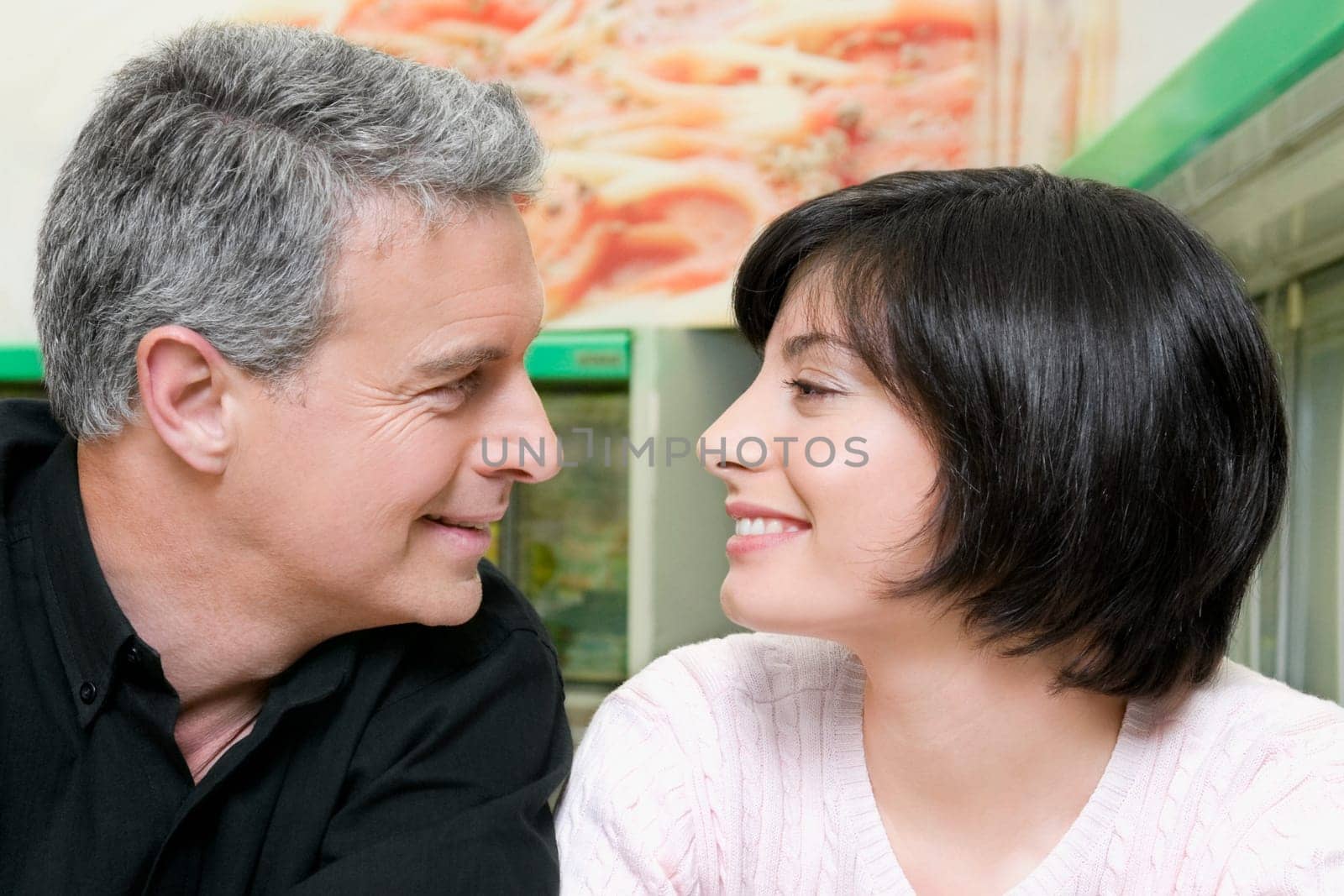 Man with his daughter smiling in a supermarket