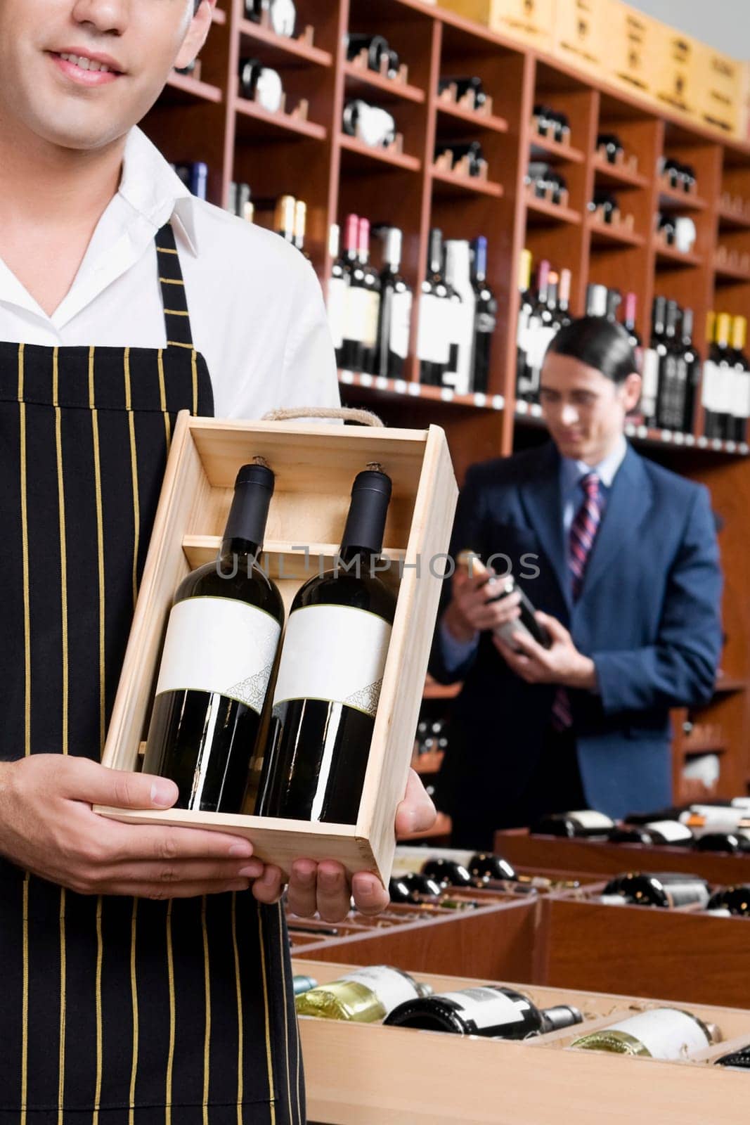 Sales clerk holding a crate of wine bottles