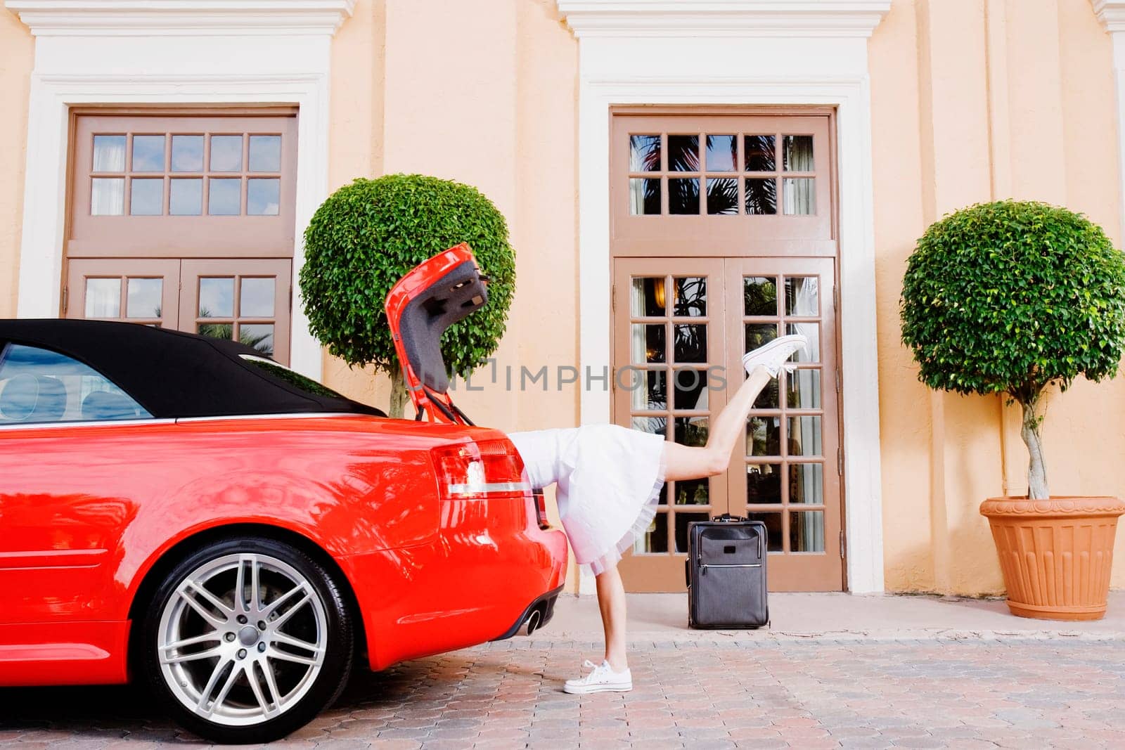 Woman looking in a car trunk, Biltmore Hotel, Coral Gables, Florida, USA