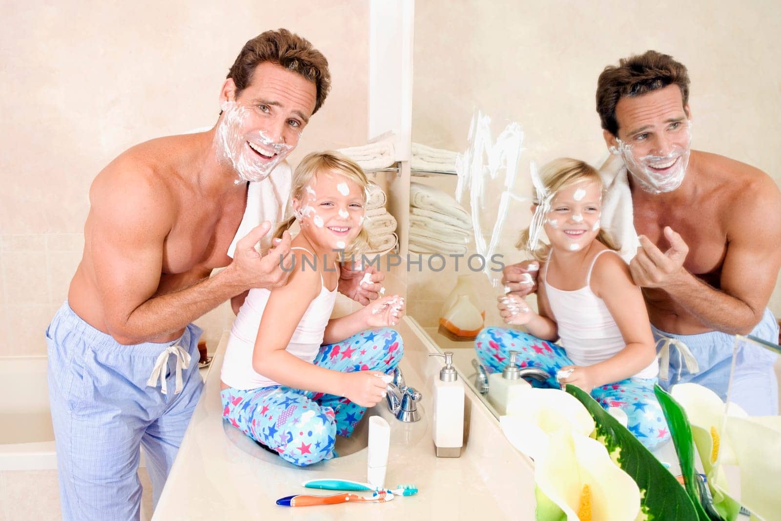 Girl playing with her father in the bathroom