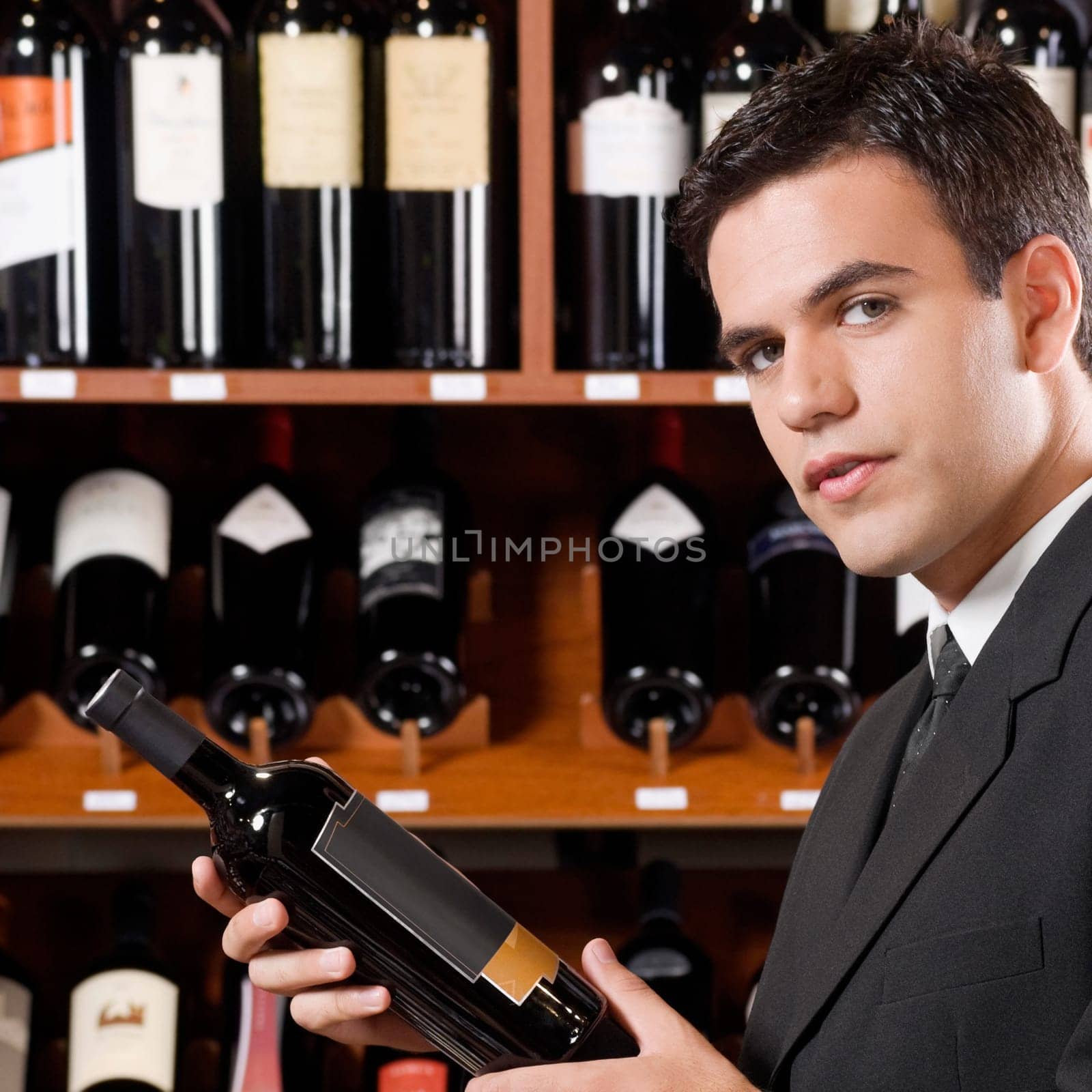 Businessman holding a wine bottle
