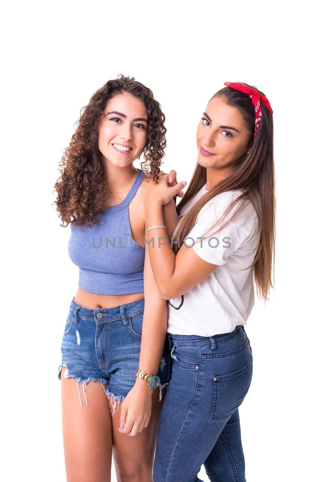 Two friends posing in studio isolated over a white background