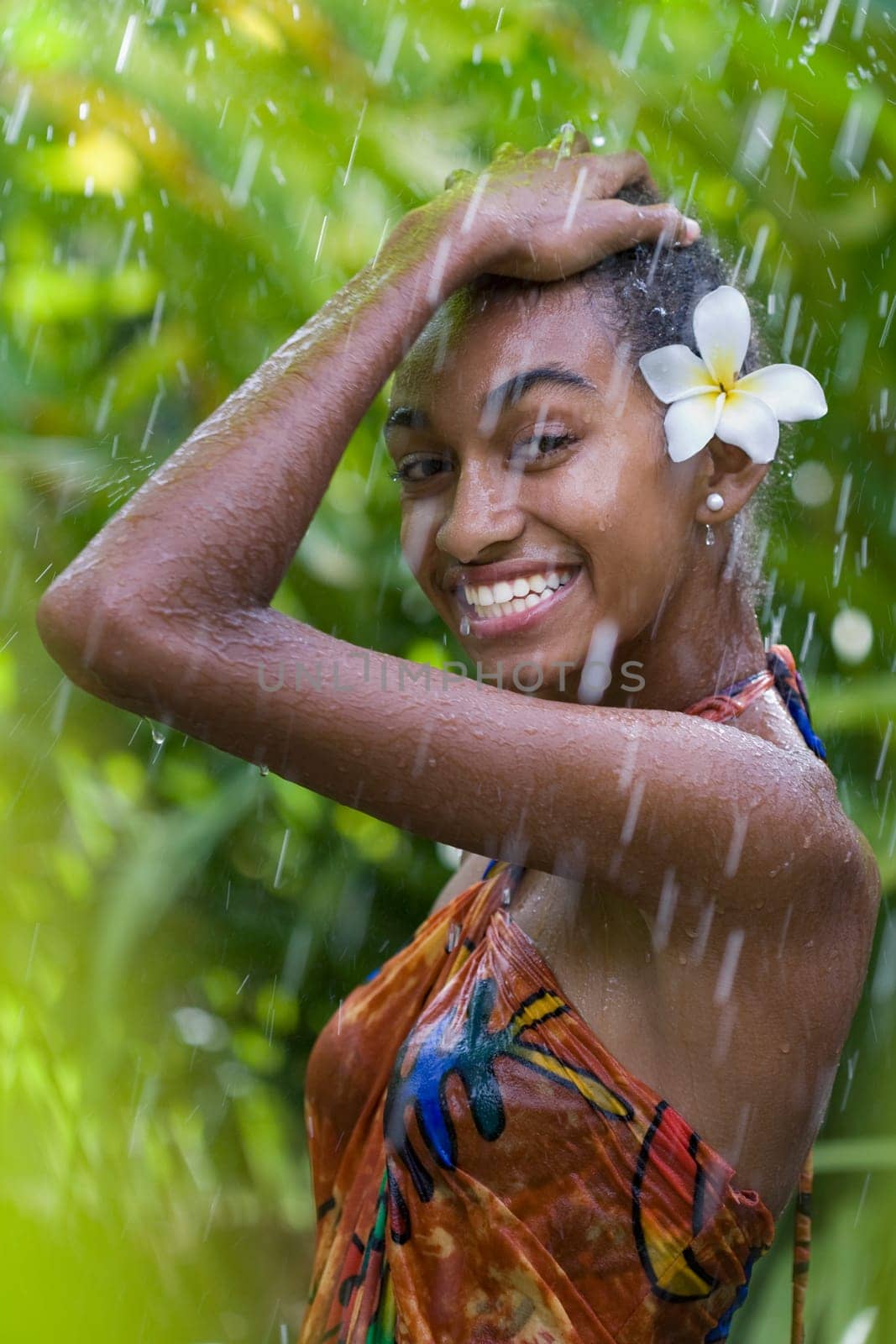 Portrait of a woman enjoying rain shower