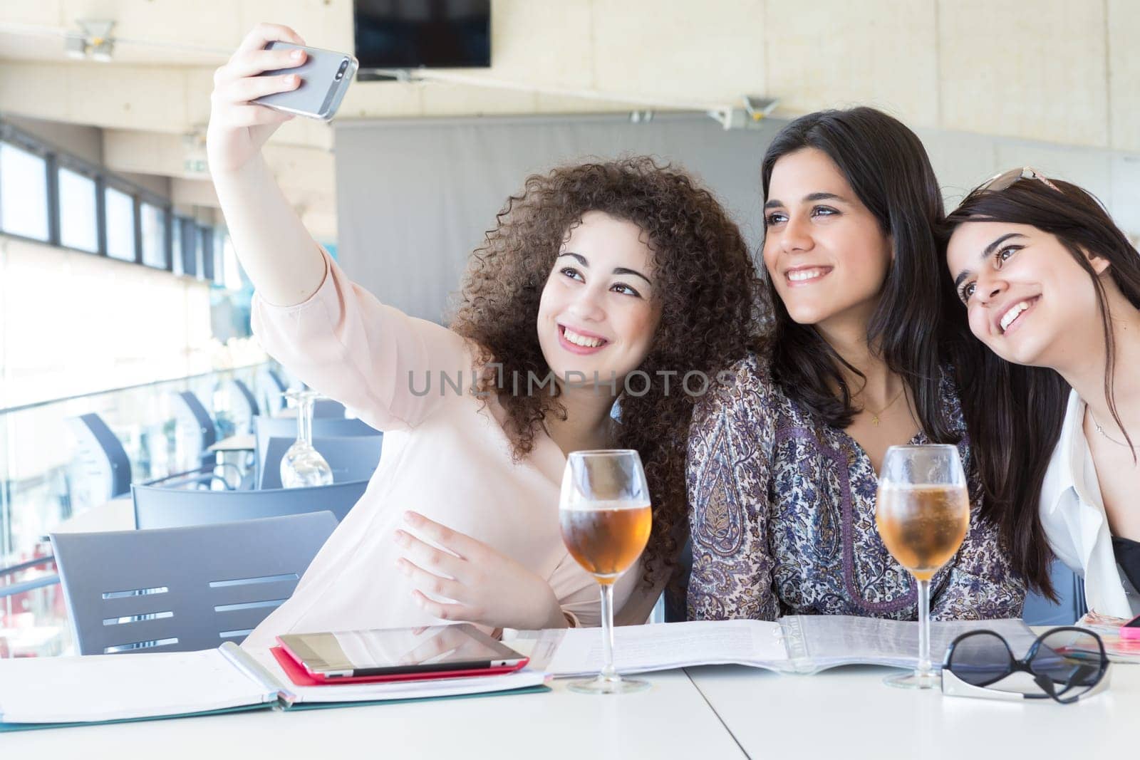 Group of happy students preparing their exams or simply relaxing at a bar