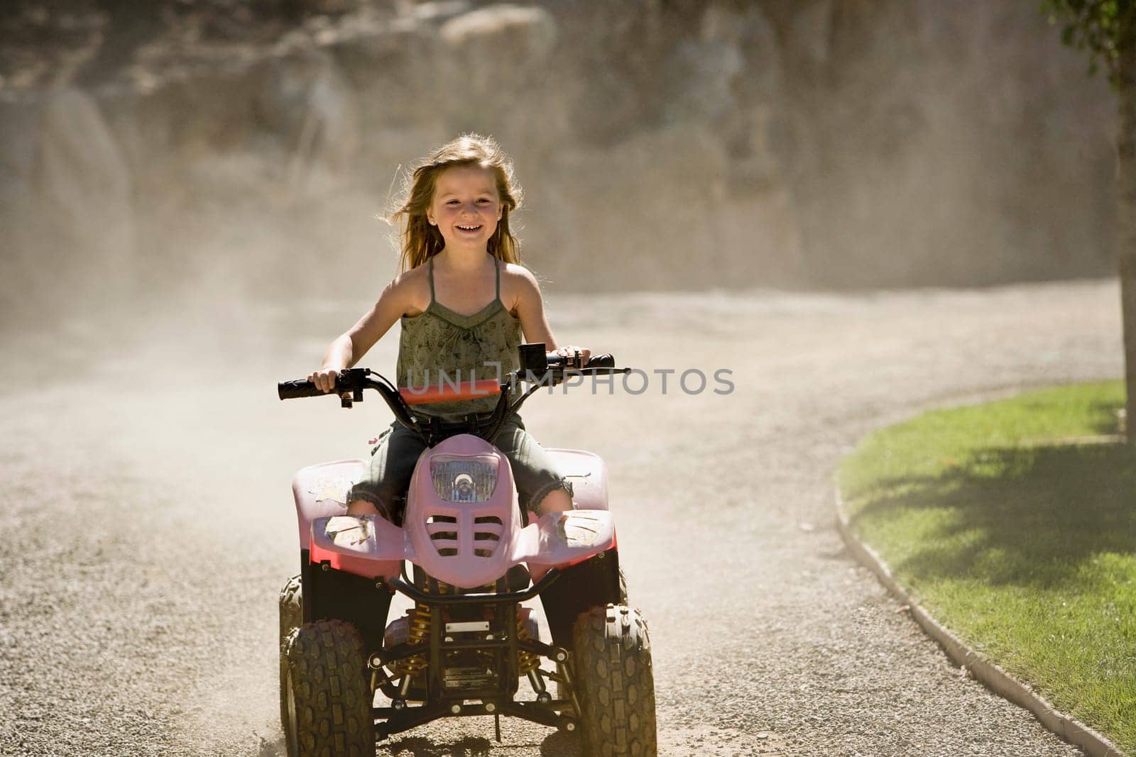 Girl riding a quadbike and smiling