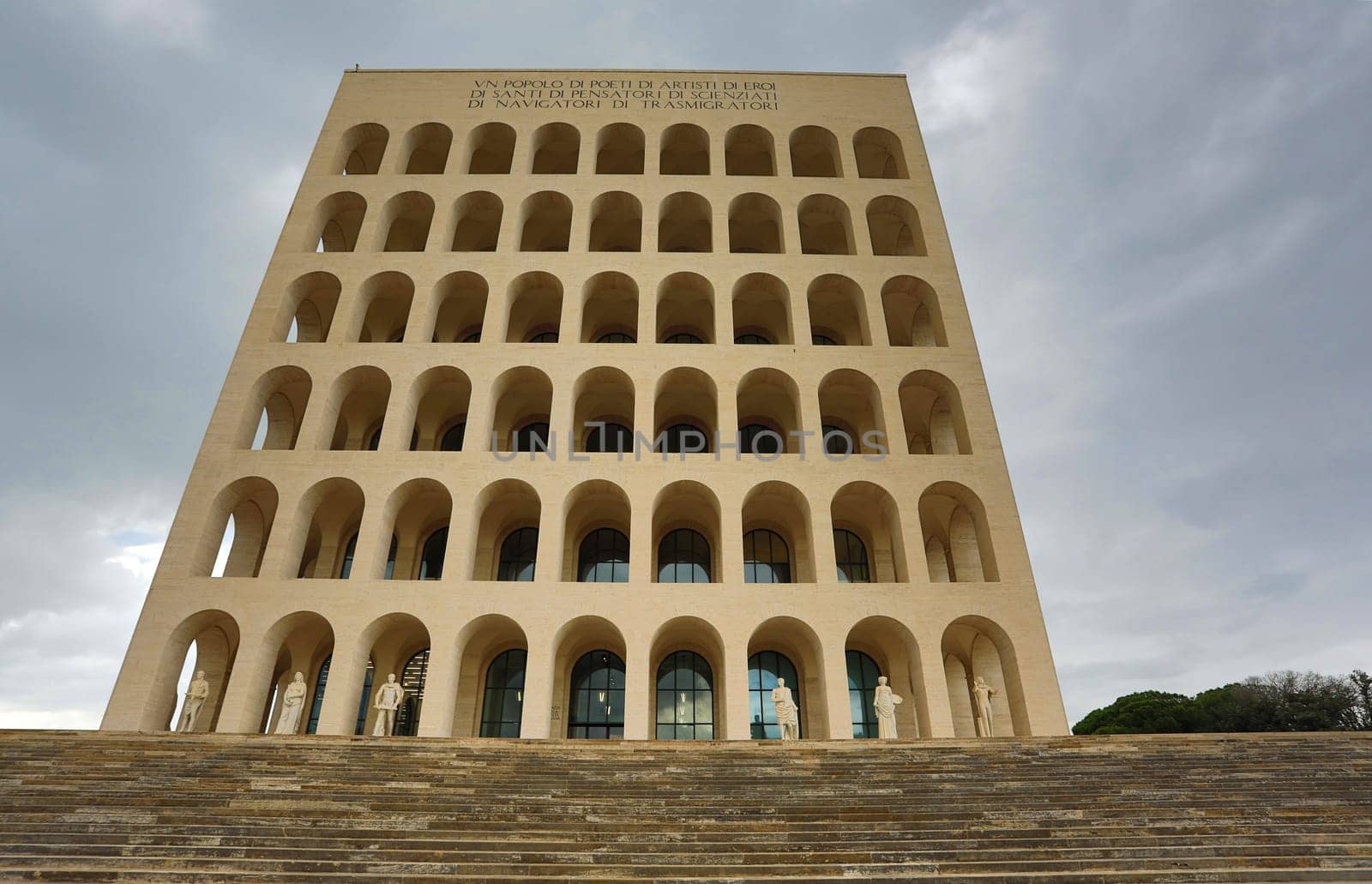 Rome, Italy - October 5, 2018: Palazzo della Civilta Italiana. The inscription reads: "A nation of poets, of artists, of heroes, of saints, of thinkers, of scientists, of navigators, of migrants"""
