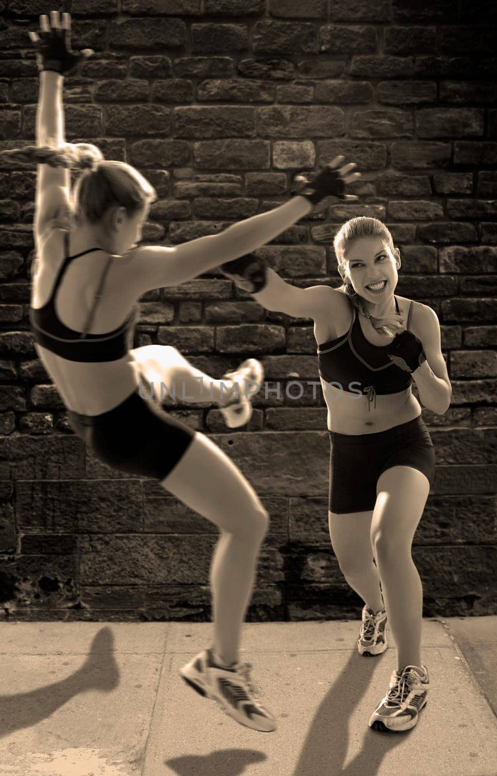 Two young women boxing