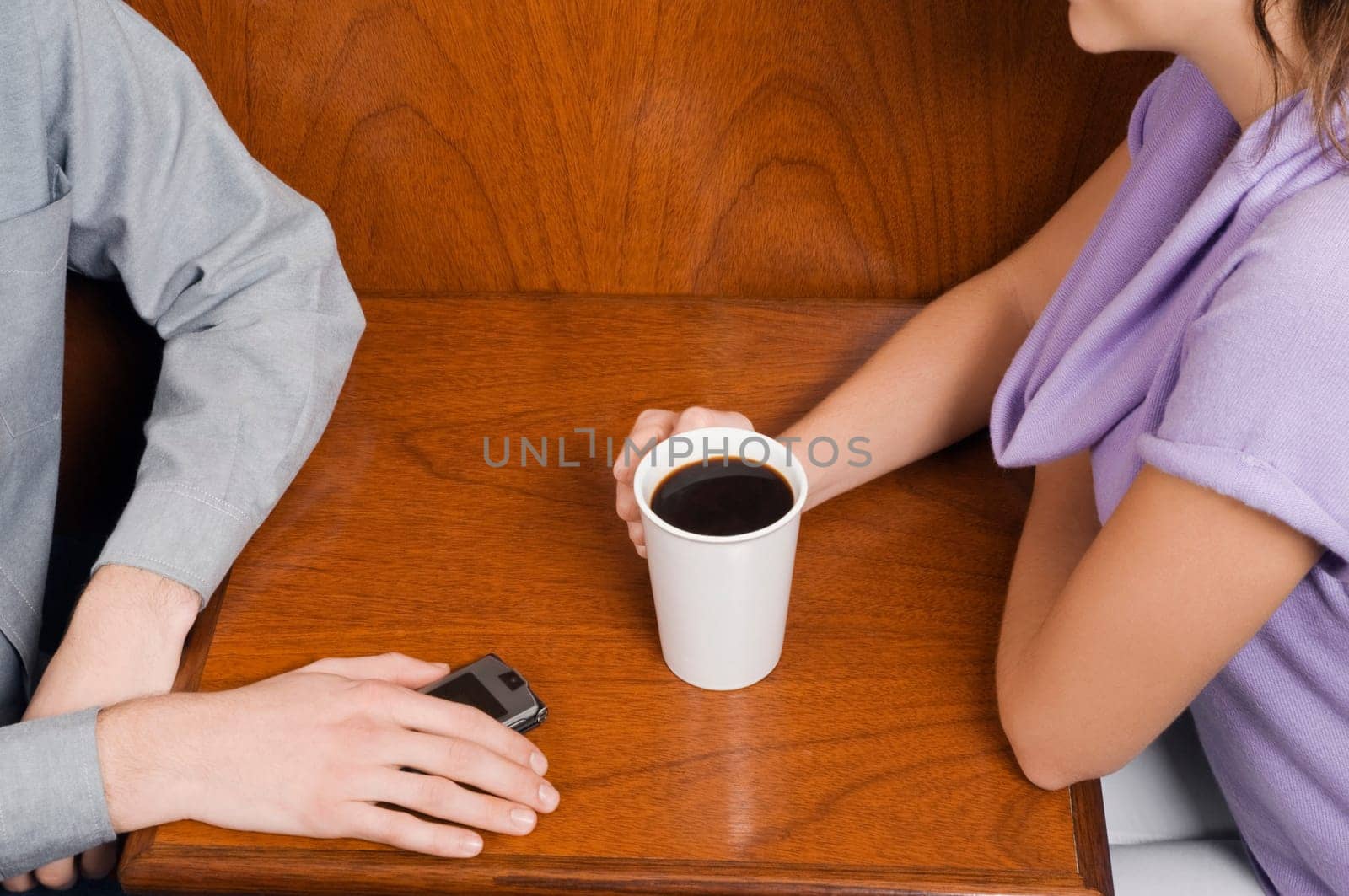Mid section view of a couple sitting in a cafe