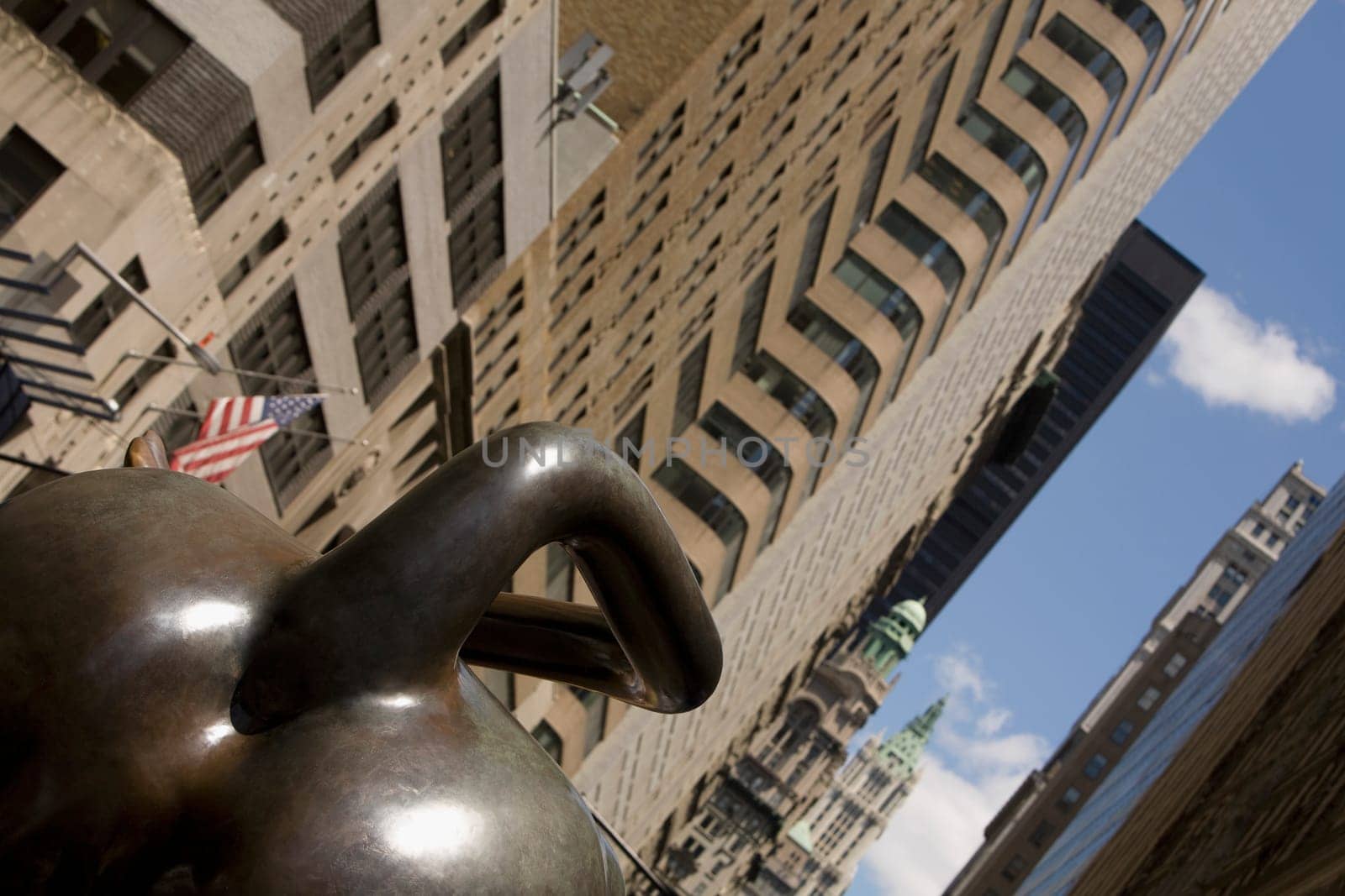 Bull statue with buildings in the background, Charging Bull, New York City, New York State, USA