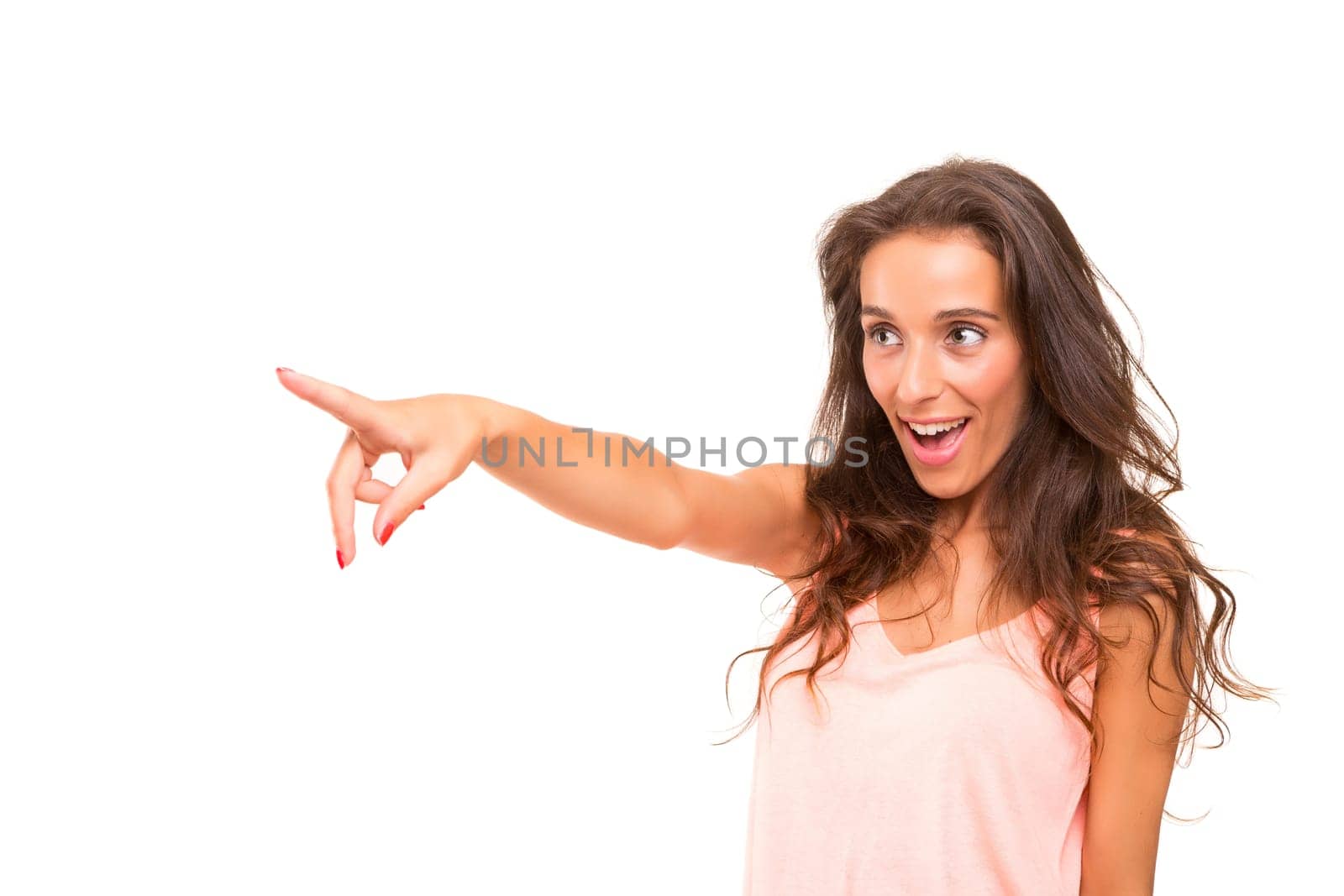 A beautiful woman pointing to something, isolated over a white background